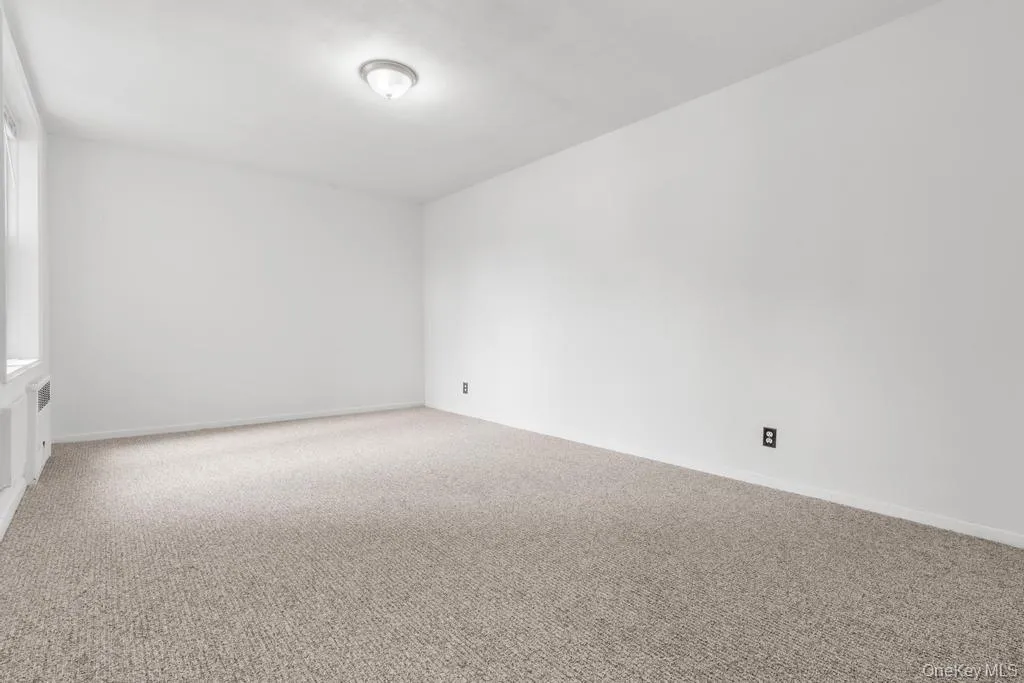 Unfurnished room featuring carpet floors and baseboards Unfurnished room featuring carpet floors and baseboards