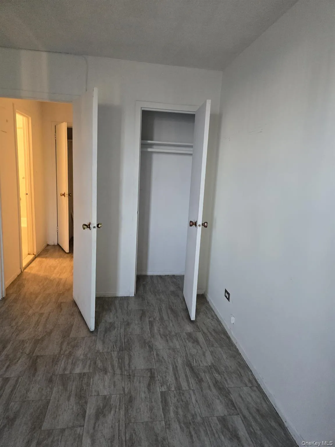 Unfurnished bedroom with a closet and baseboards Unfurnished bedroom with a closet and baseboards