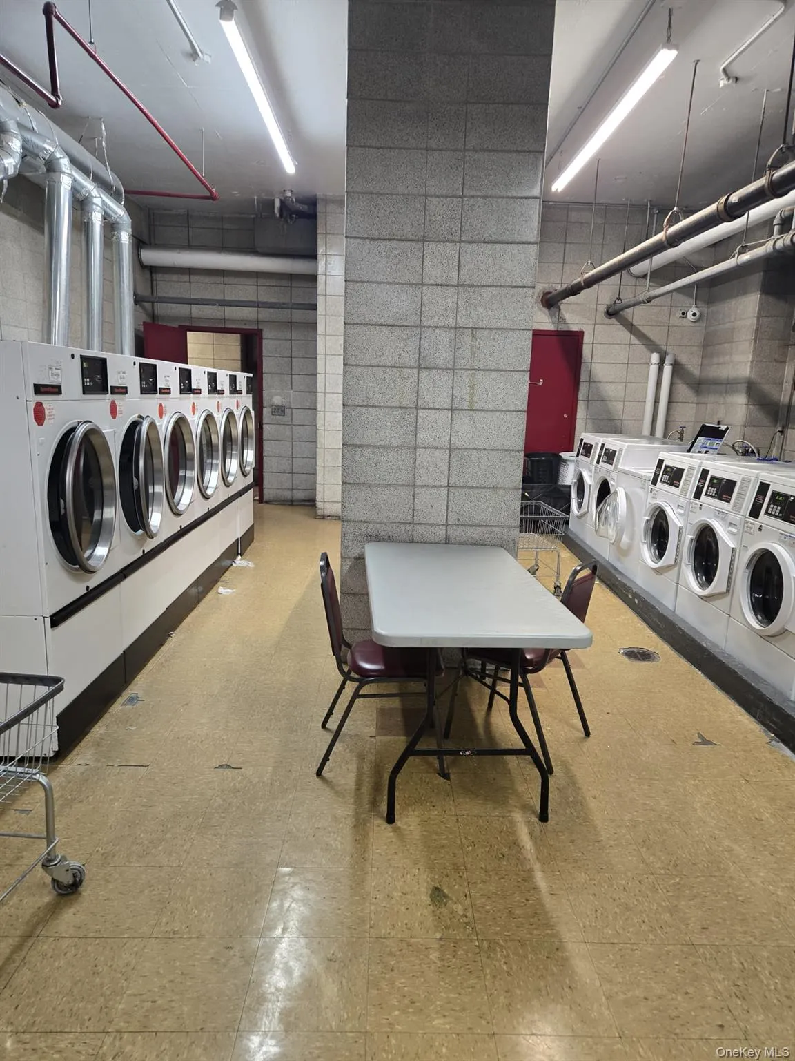 Community laundry room with separate washer and dryer Community laundry room with separate washer and dryer