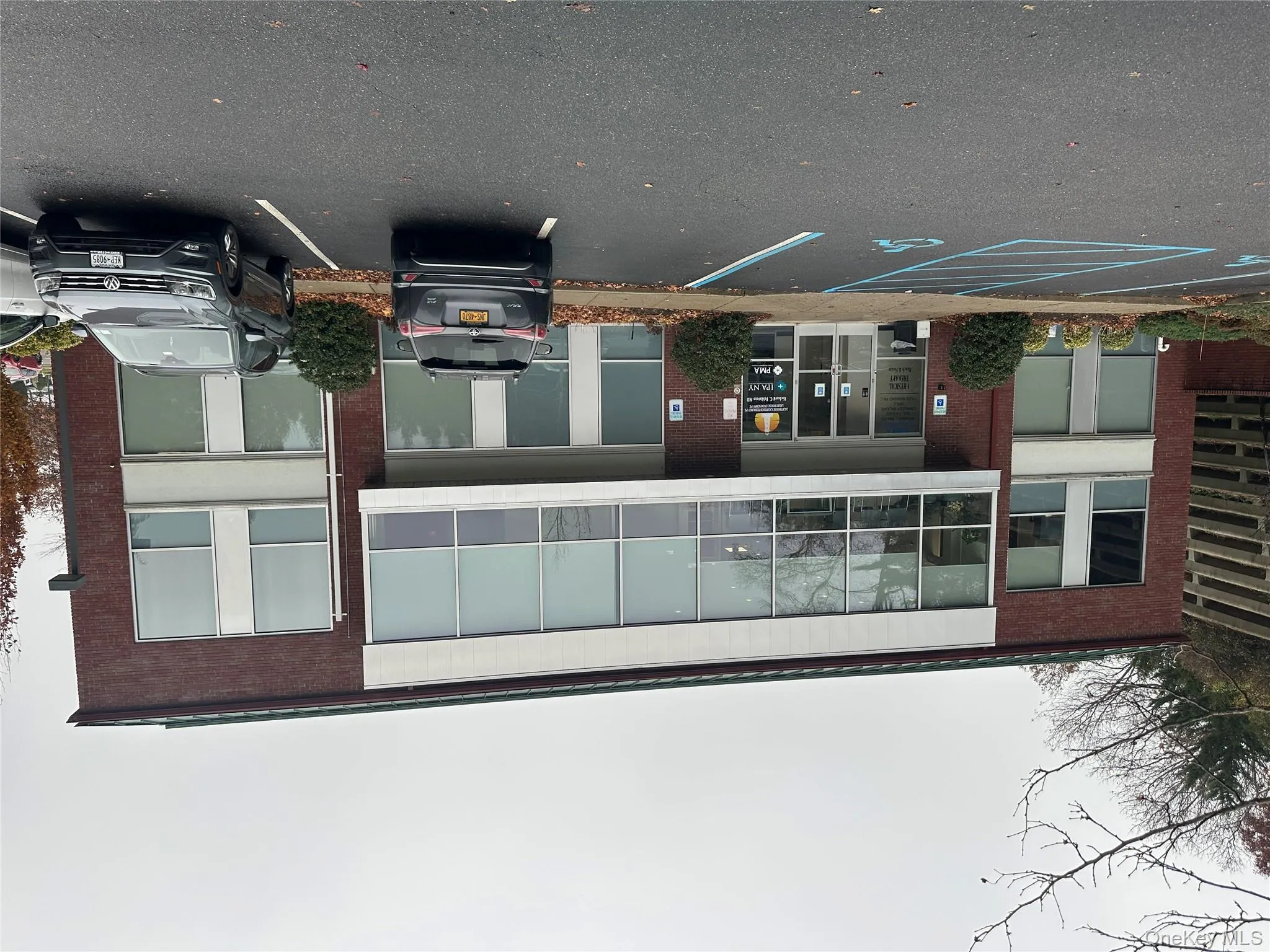 View of apartment building / complex with uncovered parking View of apartment building / complex with uncovered parking