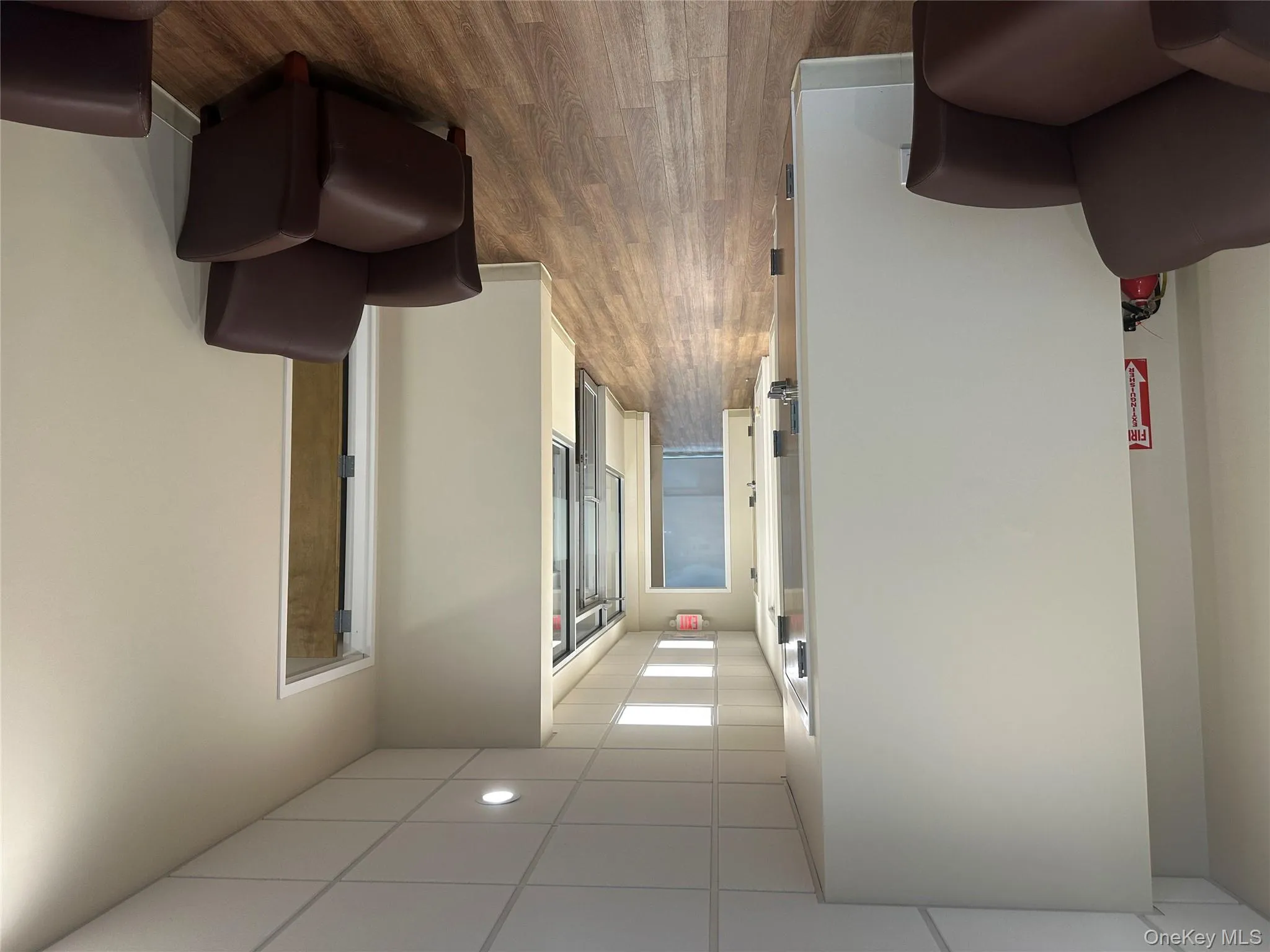 Hall featuring a drop ceiling and dark wood-type flooring Hall featuring a drop ceiling and dark wood-type flooring