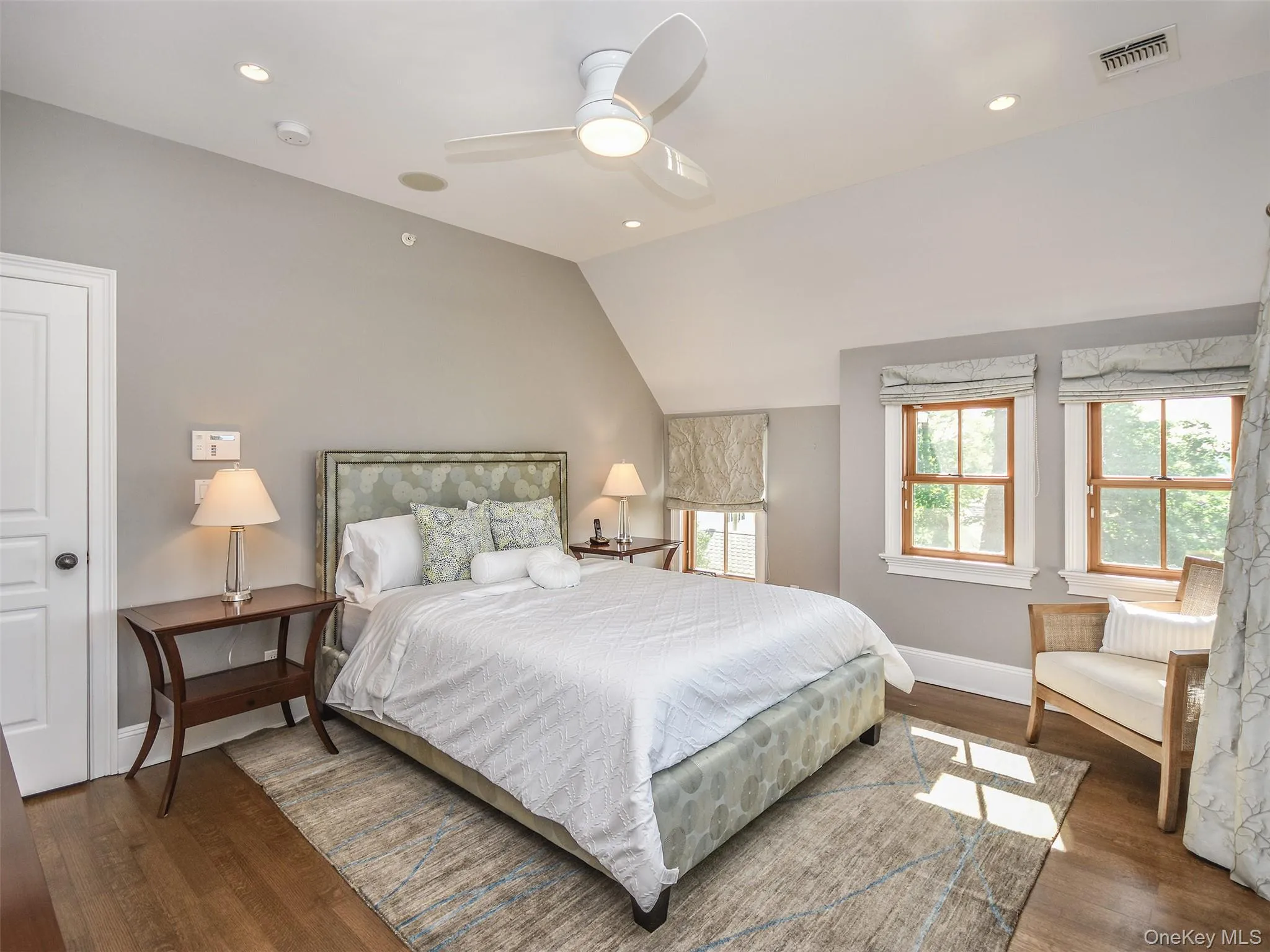 Primary Bedroom with vaulted ceiling, dark wood-style floors, ceiling fan, and recessed lighting Primary Bedroom with vaulted ceiling, dark wood-style floors, ceiling fan, and recessed lighting