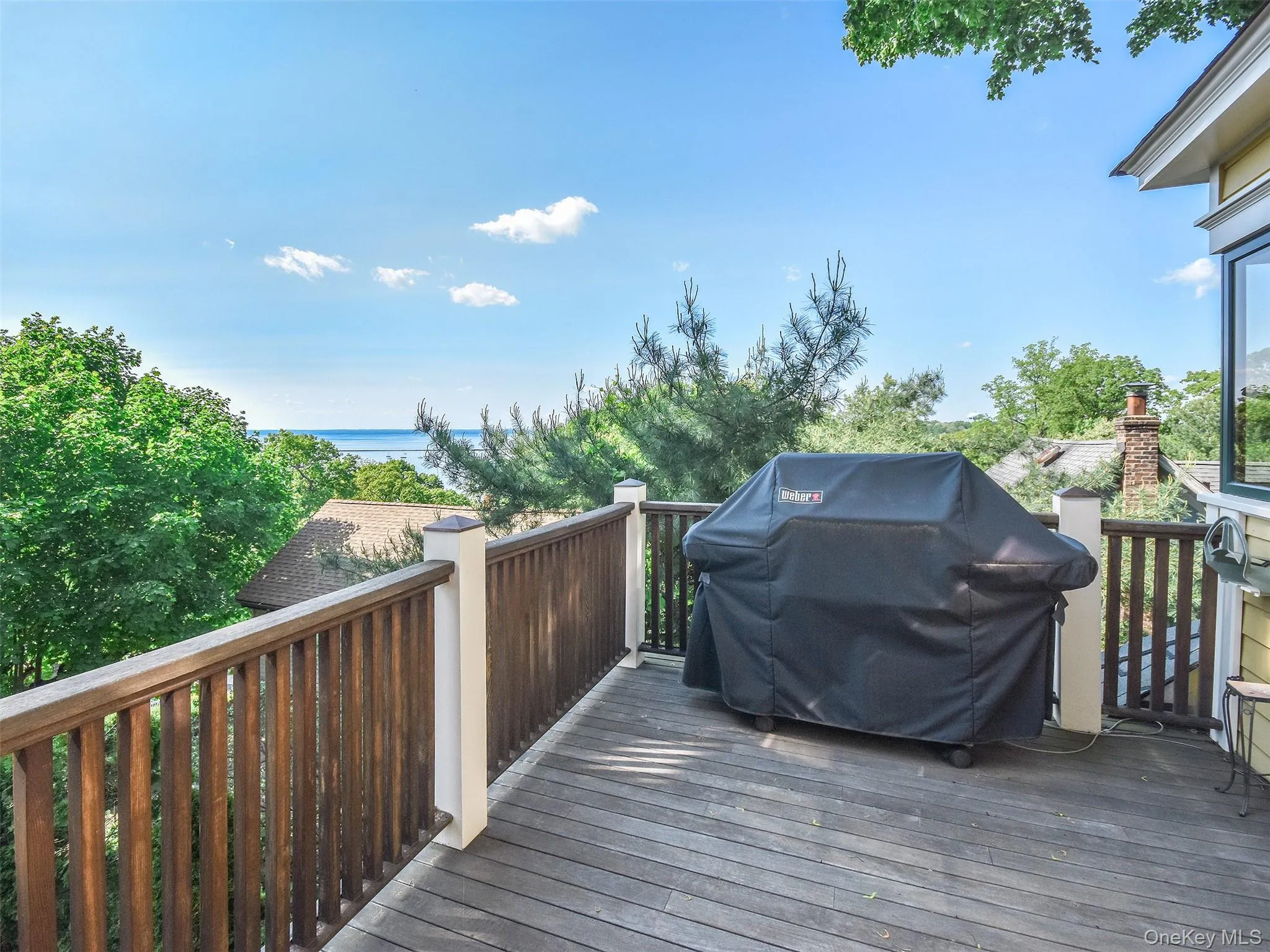 Wooden terrace featuring grilling area Wooden terrace featuring grilling area