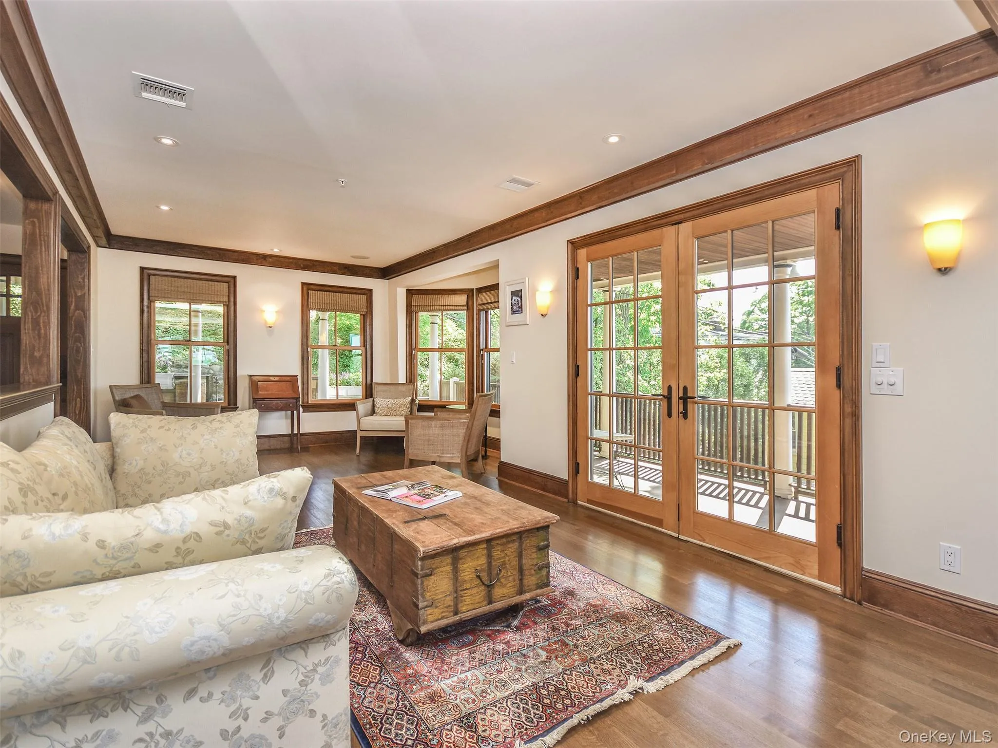 Living area with wood finished floors, French doors, recessed lighting, and crown molding Living area with wood finished floors, French doors, recessed lighting, and crown molding