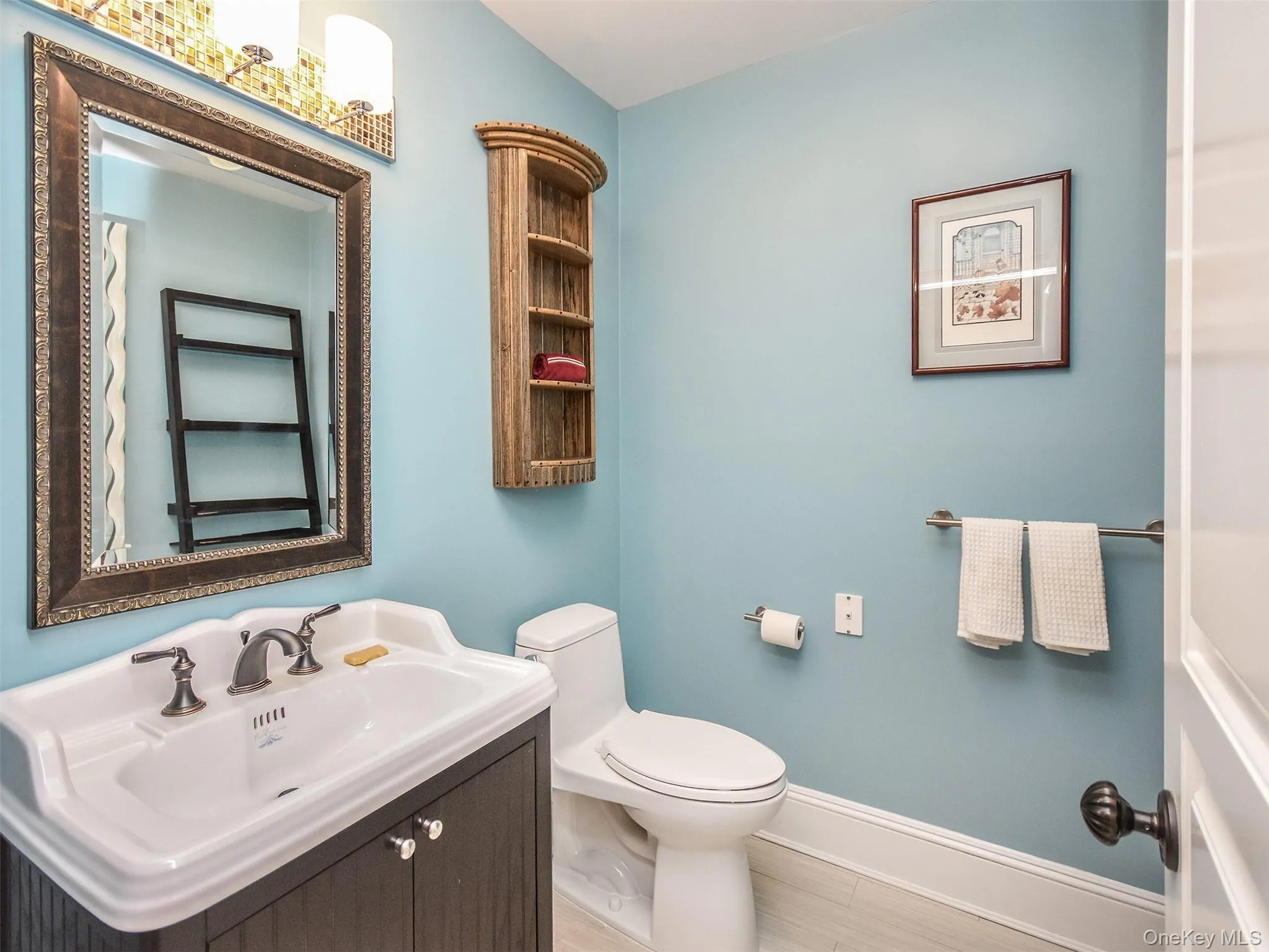 Half bathroom, off of the butler's pantry, featuring baseboards and vanity Half bathroom, off of the butler's pantry, featuring baseboards and vanity