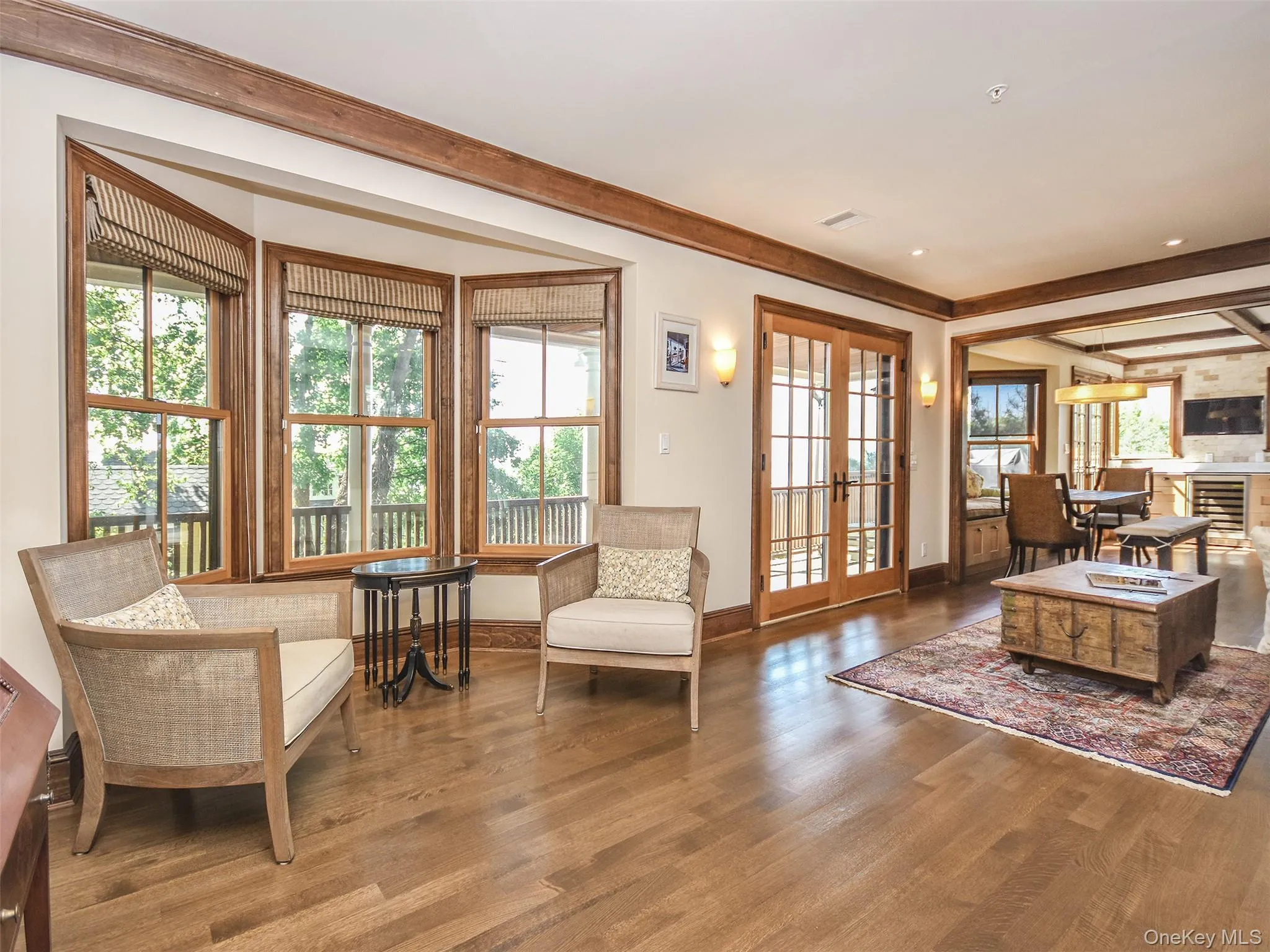 Living room has bay windows and doors out to the wrap around deck Living room has bay windows and doors out to the wrap around deck