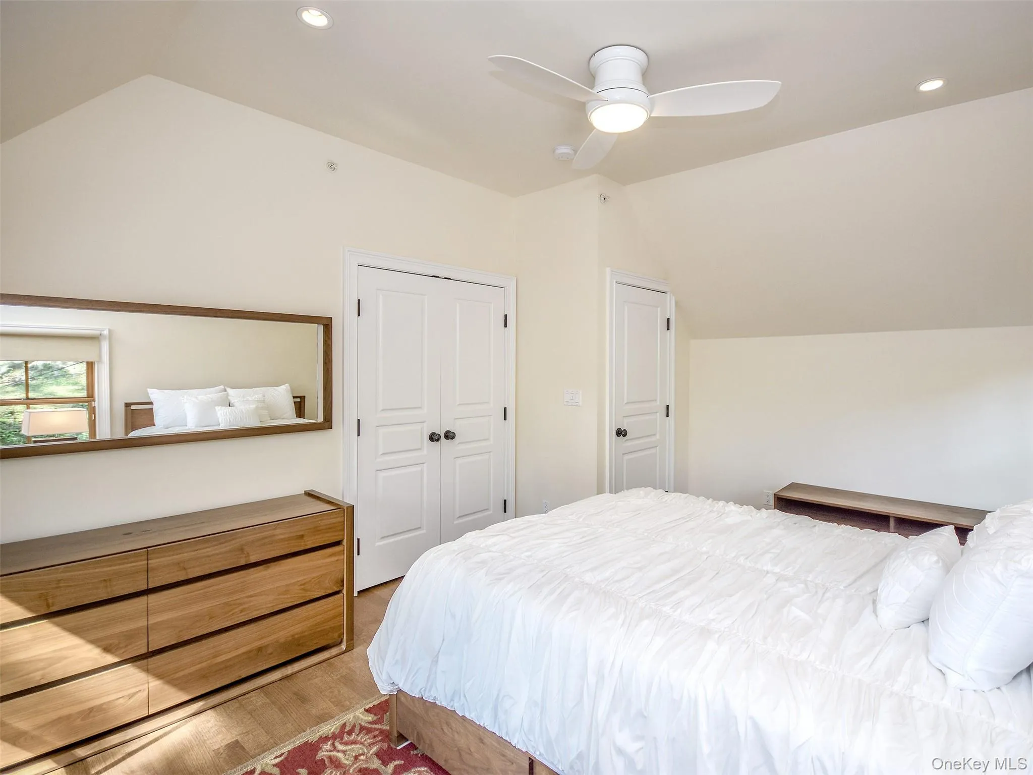 2nd fl. Bedroom with lofted ceiling, recessed lighting, wood finished floors, a ceiling fan, and a closet 2nd fl. Bedroom with lofted ceiling, recessed lighting, wood finished floors, a ceiling fan, and a closet