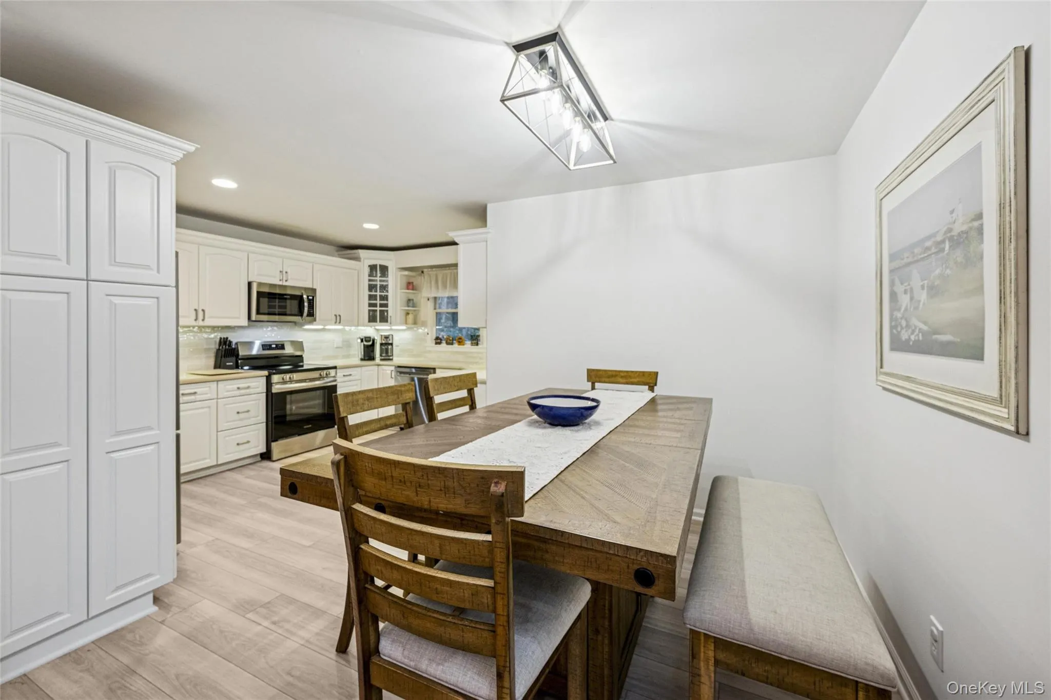 Dining area with recessed lighting and light wood-type flooring Dining area with recessed lighting and light wood-type flooring