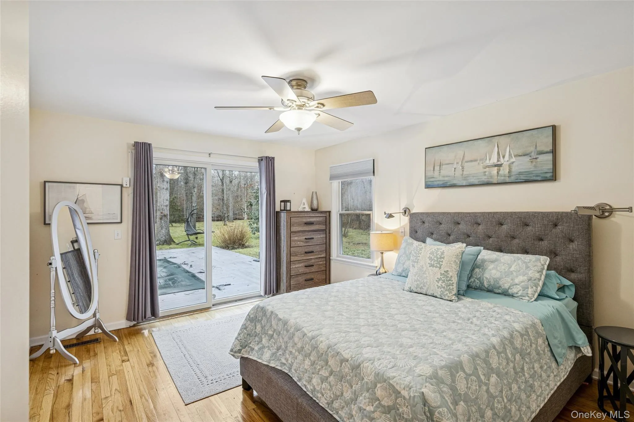 Bedroom with hardwood / wood-style flooring, a ceiling fan, and access to outside Bedroom with hardwood / wood-style flooring, a ceiling fan, and access to outside
