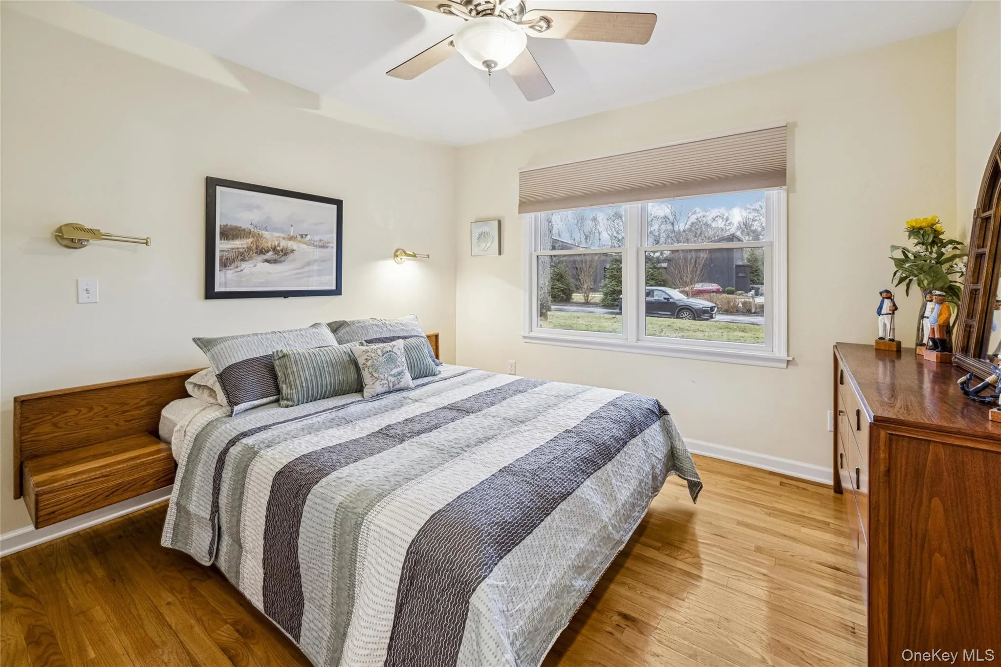 Bedroom with light wood-style flooring and a ceiling fan Bedroom with light wood-style flooring and a ceiling fan