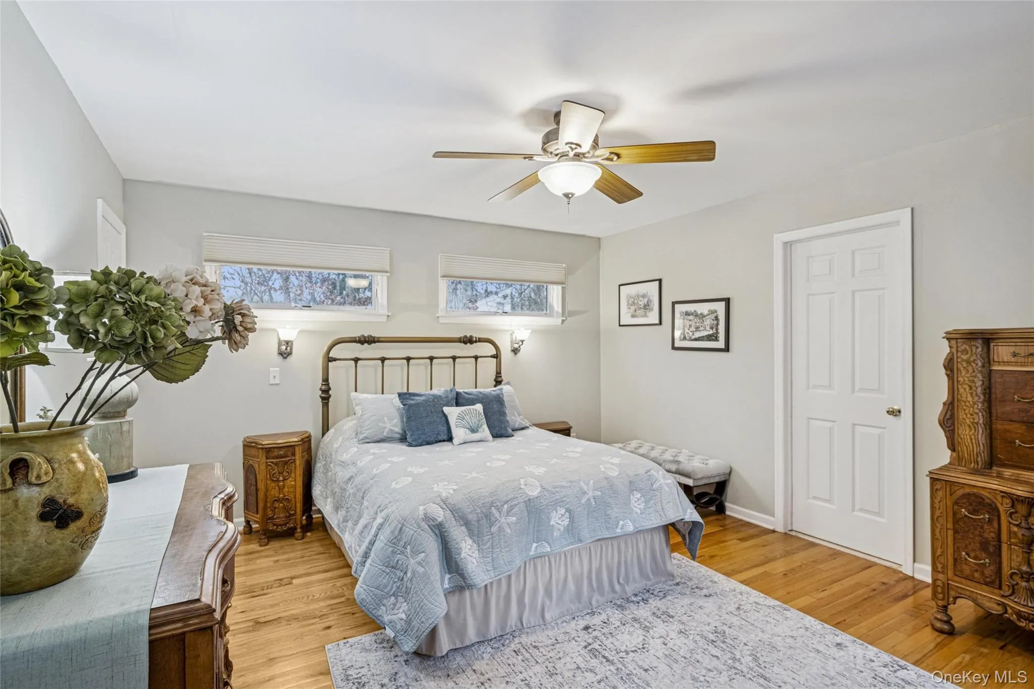 Bedroom featuring ceiling fan and light wood-style flooring Bedroom featuring ceiling fan and light wood-style flooring
