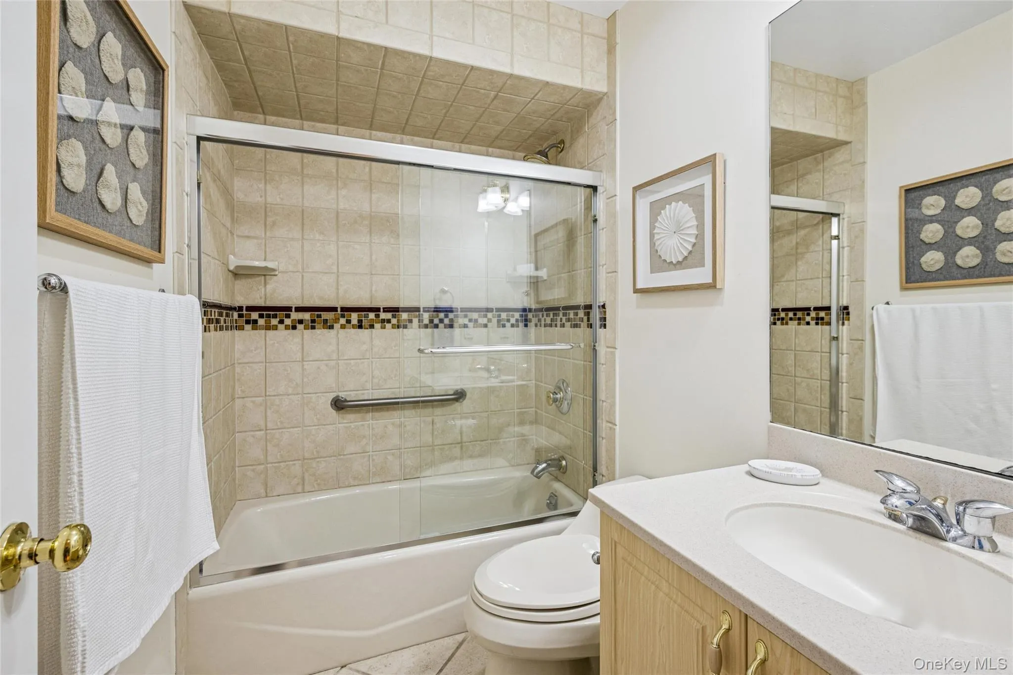 Bathroom featuring vanity and shower / bath combination with glass door Bathroom featuring vanity and shower / bath combination with glass door