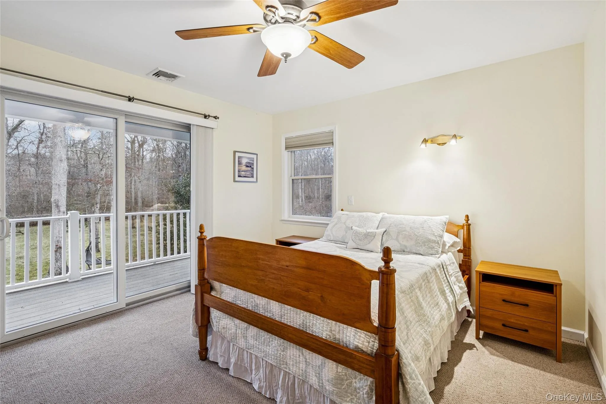 Bedroom featuring carpet floors, access to outside, and ceiling fan Bedroom featuring carpet floors, access to outside, and ceiling fan