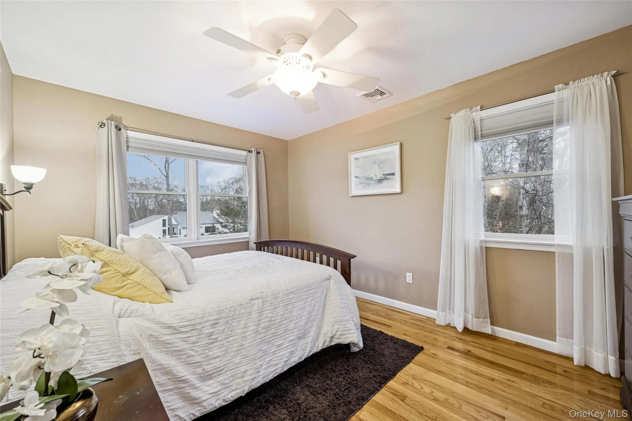 Bedroom with light wood-type flooring and ceiling fan Bedroom with light wood-type flooring and ceiling fan