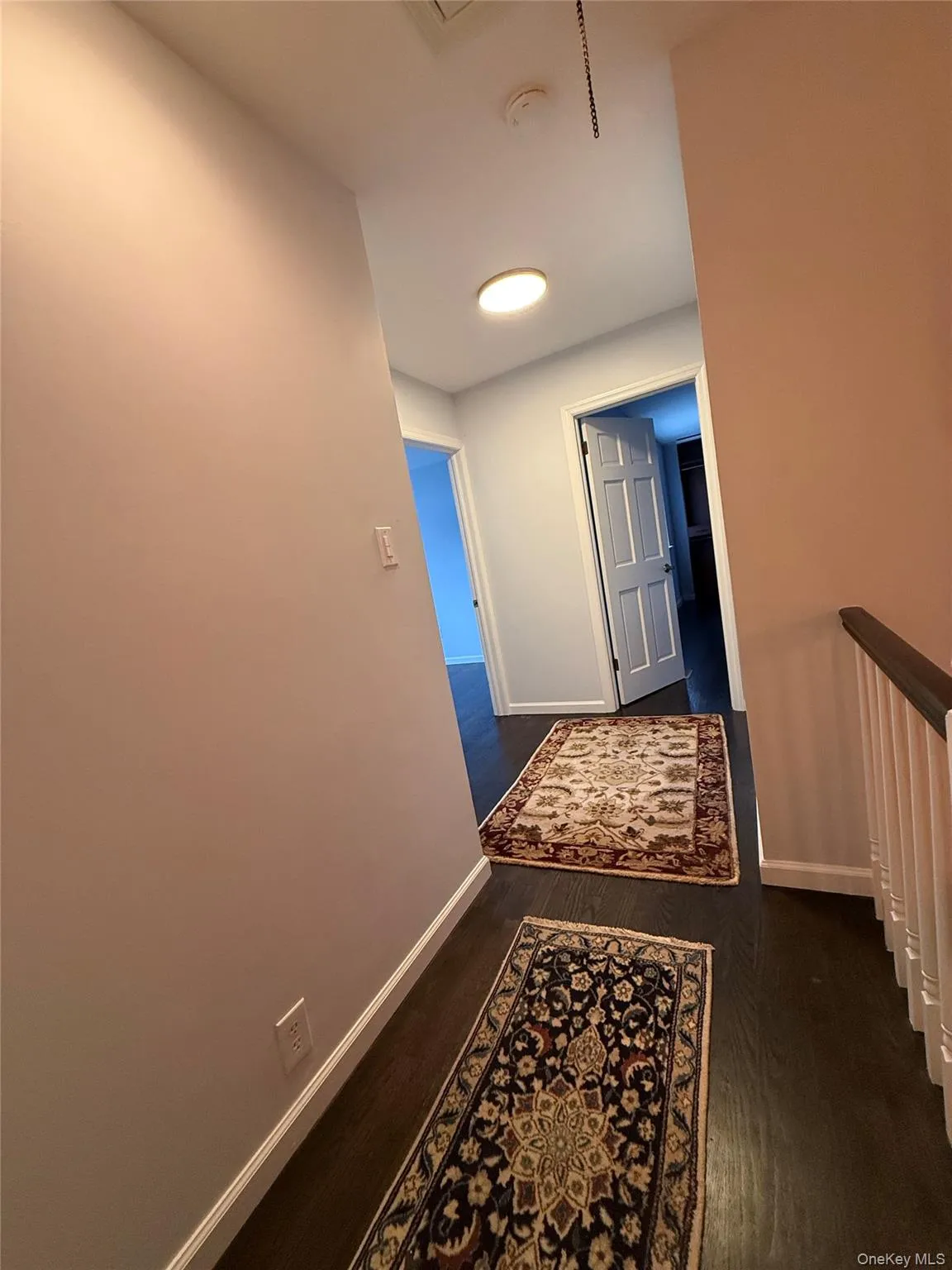 Hall with baseboards and dark wood finished floors Hall with baseboards and dark wood finished floors