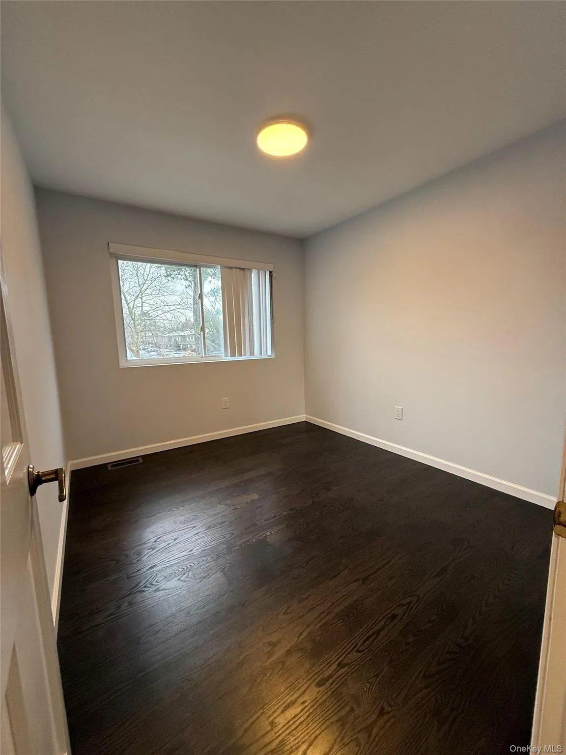 Spare room with dark wood finished floors Spare room with dark wood finished floors