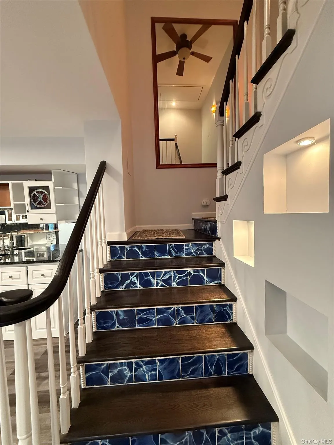 Stairs featuring ceiling fan Stairs featuring ceiling fan