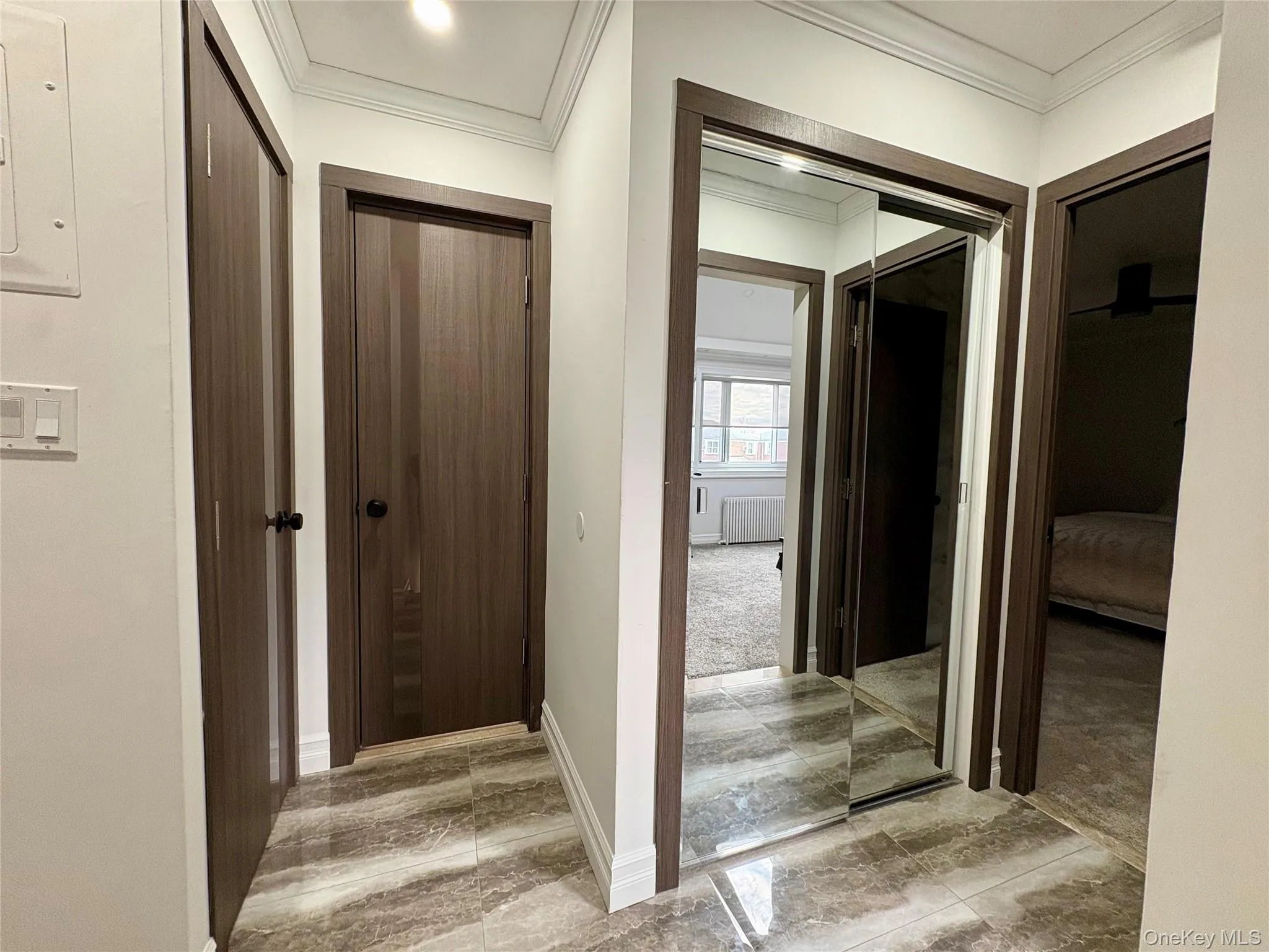 Corridor featuring radiator heating unit and crown molding Corridor featuring radiator heating unit and crown molding