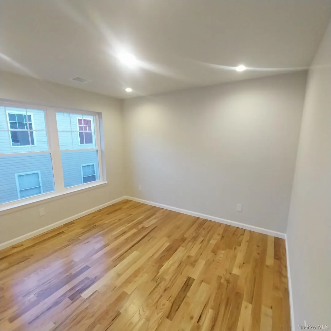 Unfurnished room with light wood-style floors and recessed lighting Unfurnished room with light wood-style floors and recessed lighting