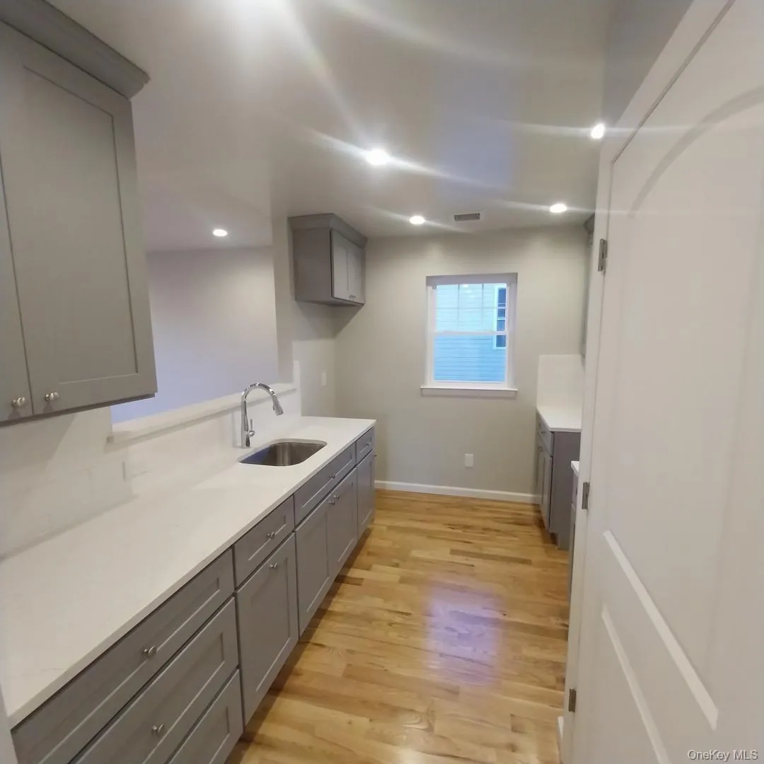 Laundry room with light wood-type flooring and recessed lighting Laundry room with light wood-type flooring and recessed lighting