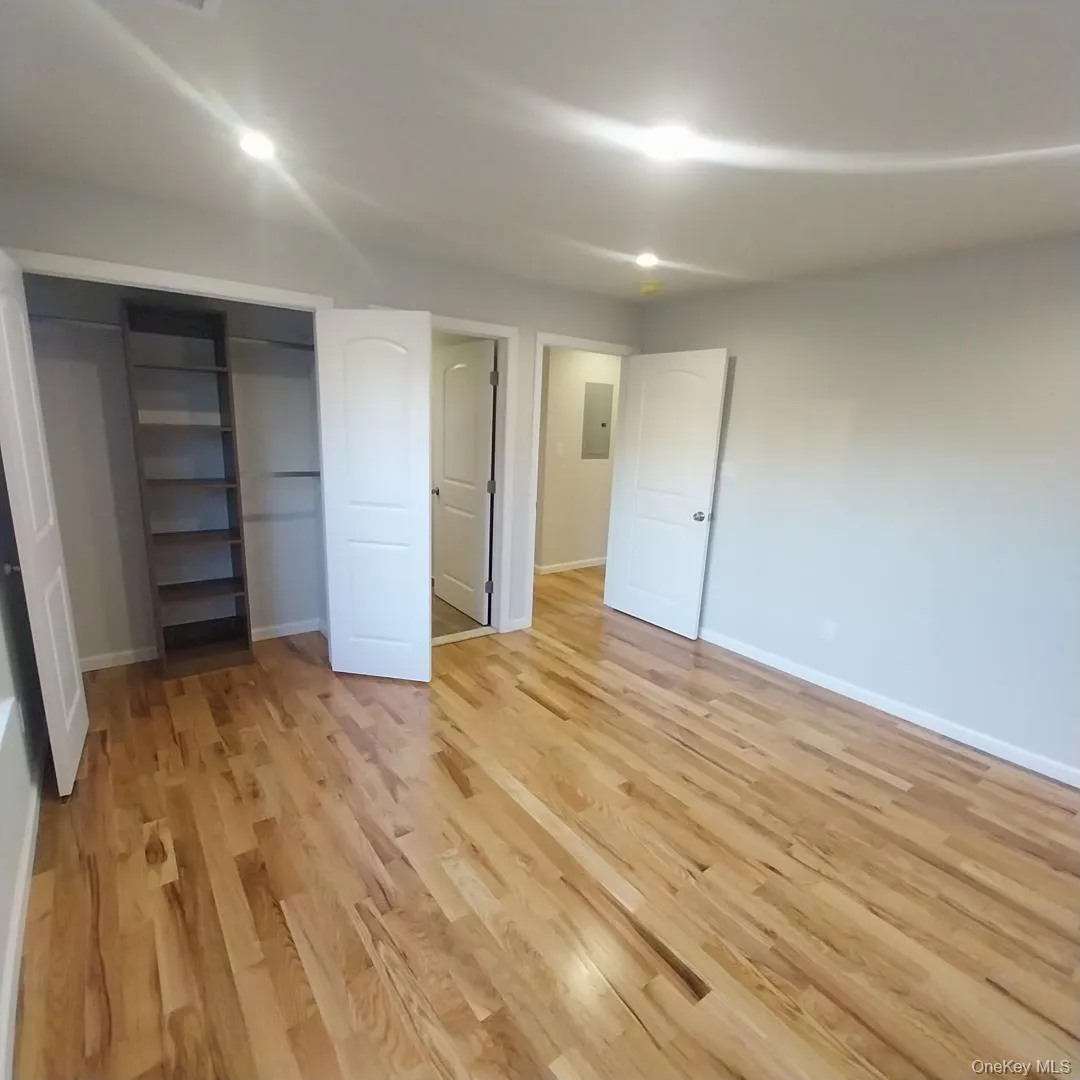 Unfurnished bedroom with light wood-style floors, a closet, and recessed lighting Unfurnished bedroom with light wood-style floors, a closet, and recessed lighting