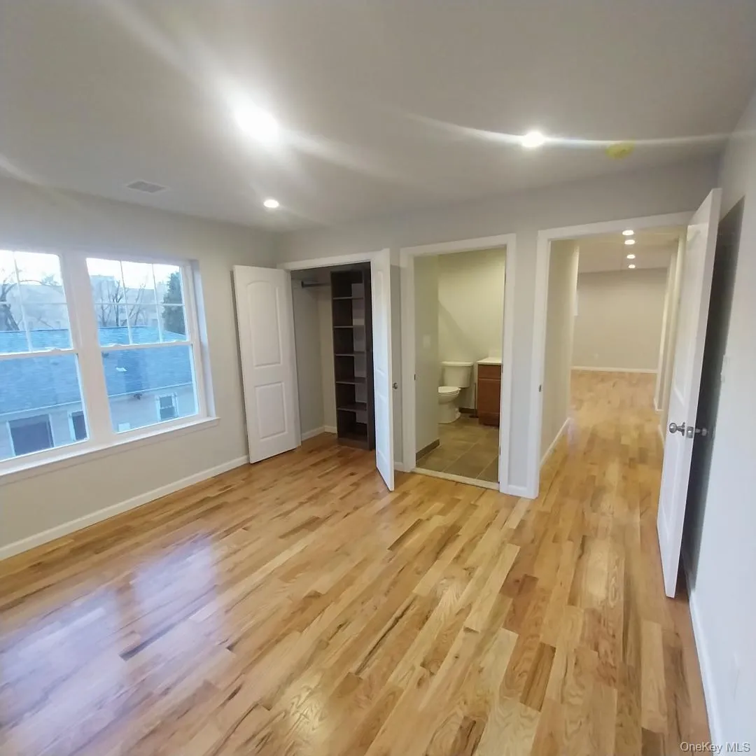 Unfurnished bedroom featuring light wood-type flooring, ensuite bathroom, and recessed lighting Unfurnished bedroom featuring light wood-type flooring, ensuite bathroom, and recessed lighting