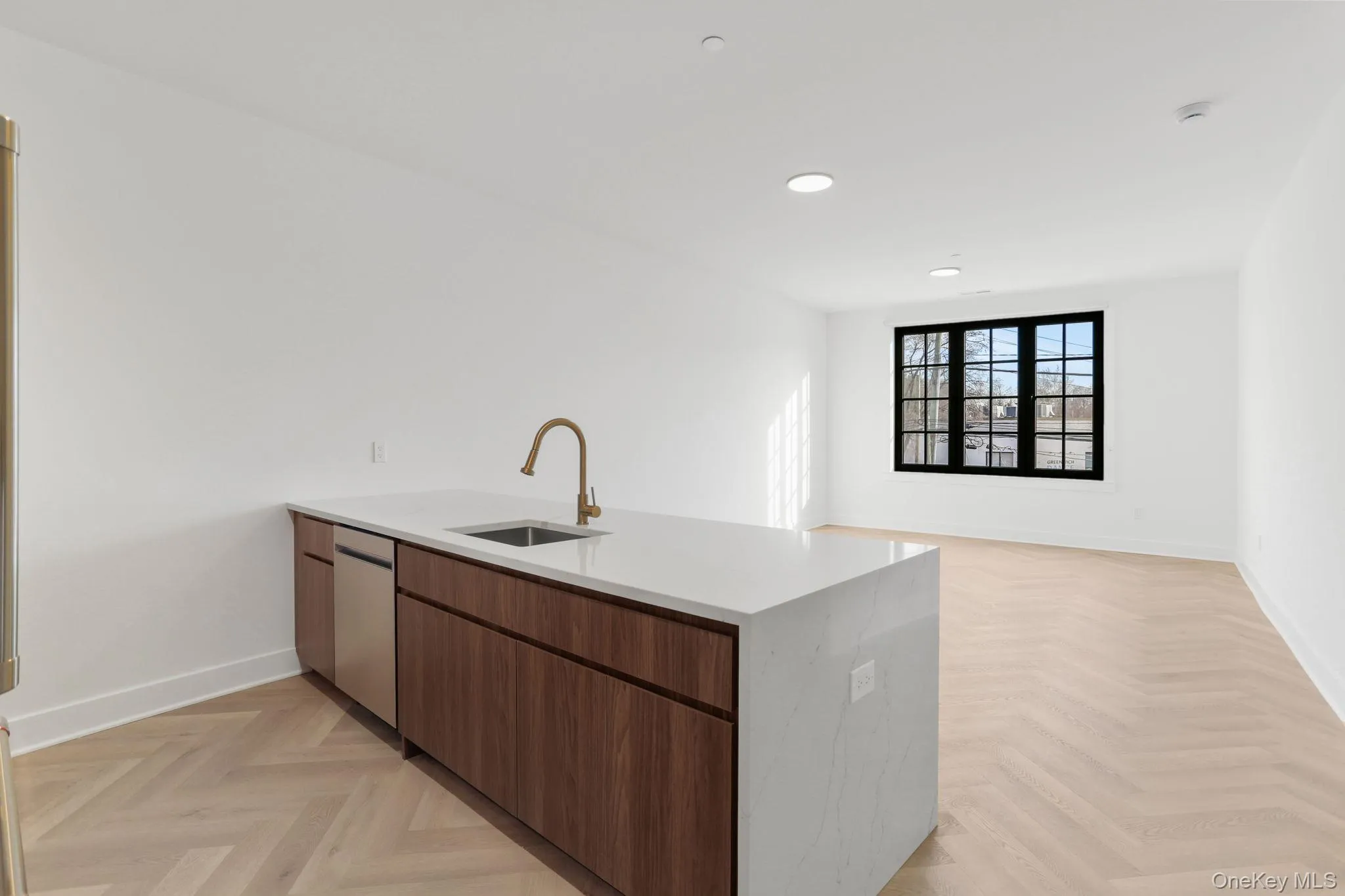 Kitchen featuring a peninsula, light stone counters, brown cabinets, modern cabinets, and dishwasher Kitchen featuring a peninsula, light stone counters, brown cabinets, modern cabinets, and dishwasher