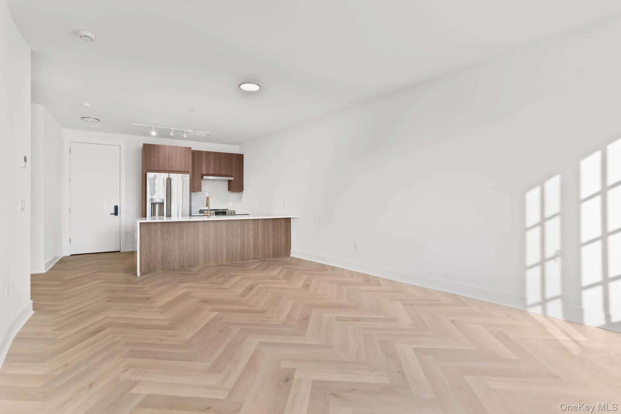 Unfurnished living room featuring baseboards Unfurnished living room featuring baseboards
