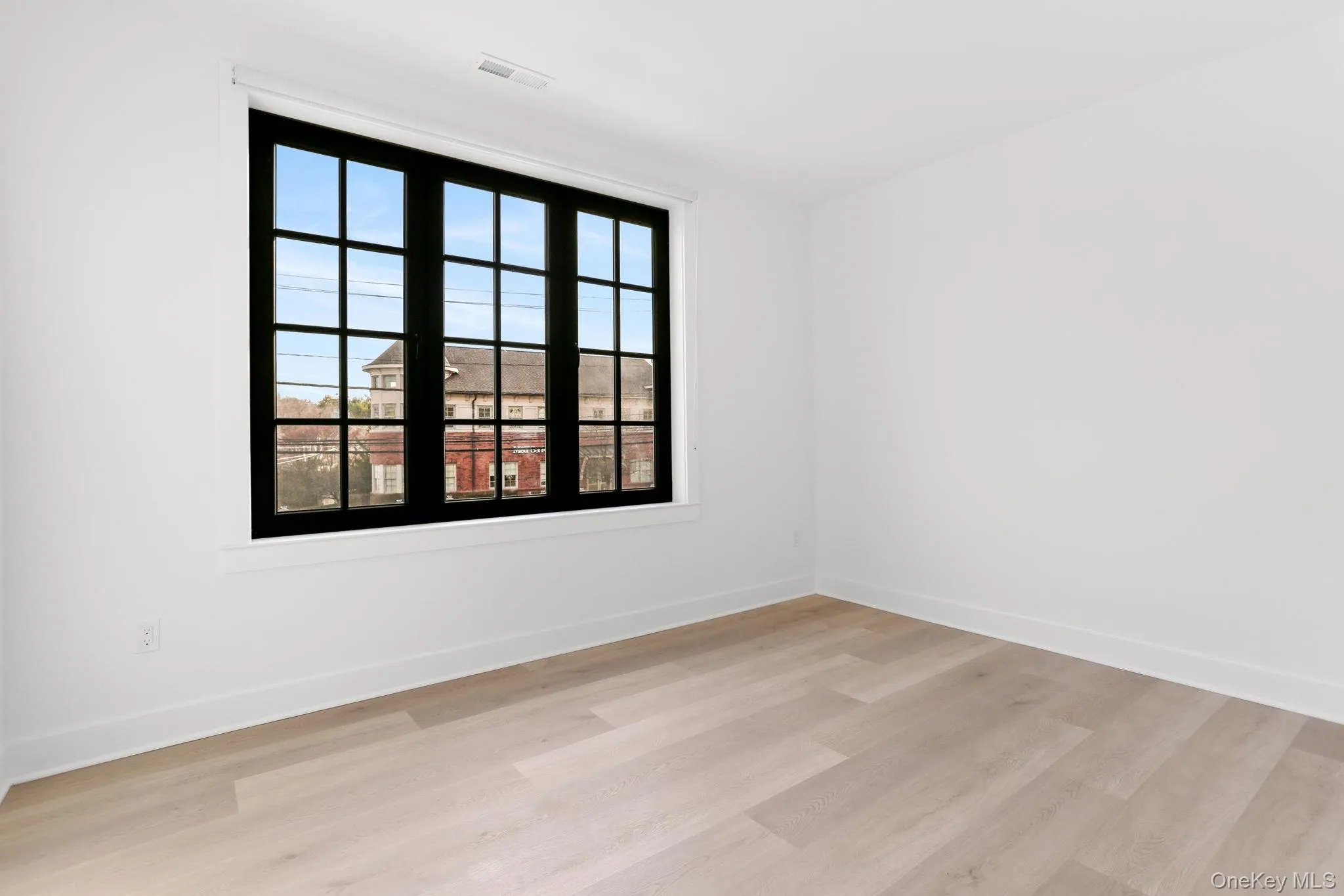 Empty room featuring baseboards and light wood-style floors Empty room featuring baseboards and light wood-style floors