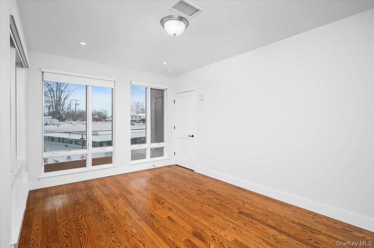 Spare room featuring wood finished floors and recessed lighting Spare room featuring wood finished floors and recessed lighting