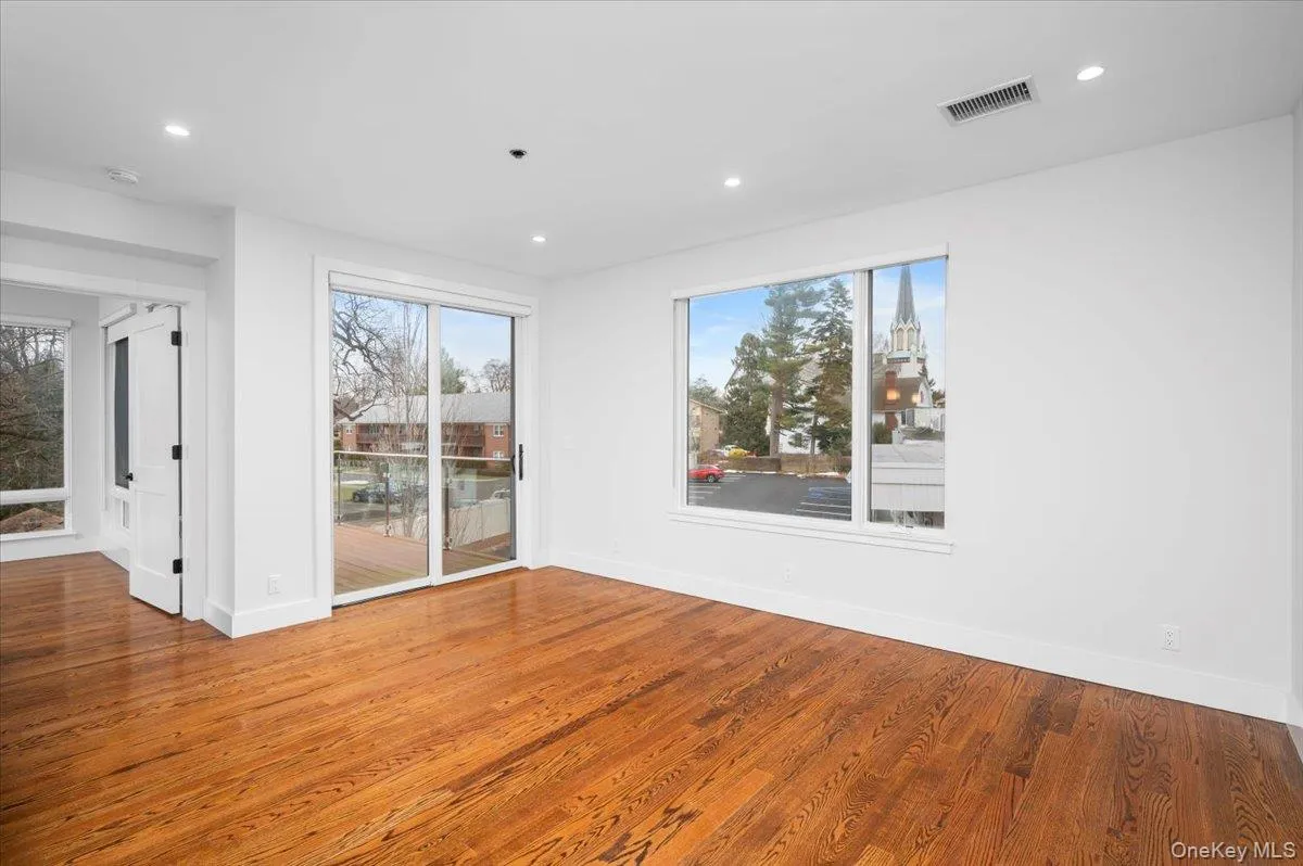 Spare room featuring wood finished floors and recessed lighting Spare room featuring wood finished floors and recessed lighting