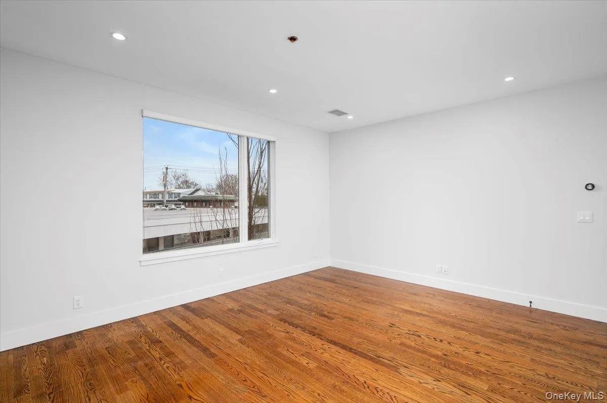 Spare room featuring wood finished floors and recessed lighting Spare room featuring wood finished floors and recessed lighting