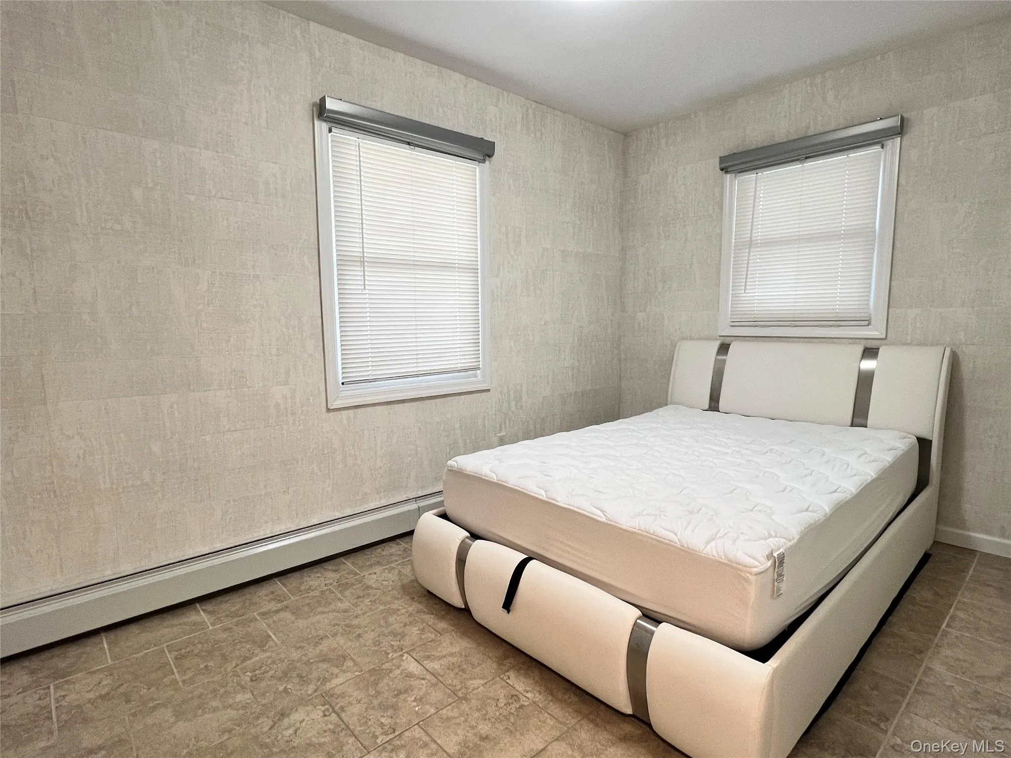 Bedroom with a baseboard radiator Bedroom with a baseboard radiator
