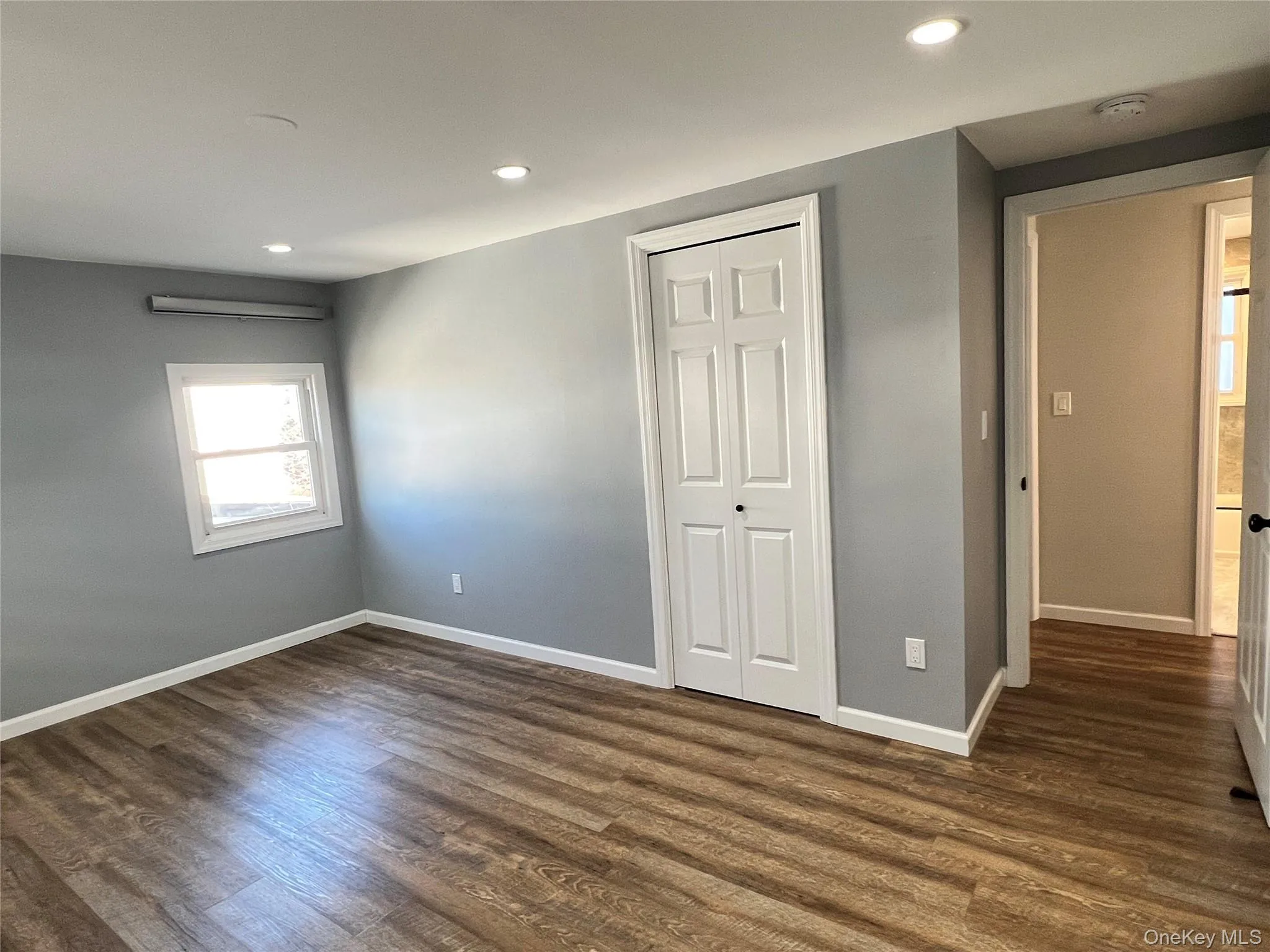 Unfurnished bedroom featuring recessed lighting, a closet, and dark wood-style flooring Unfurnished bedroom featuring recessed lighting, a closet, and dark wood-style flooring