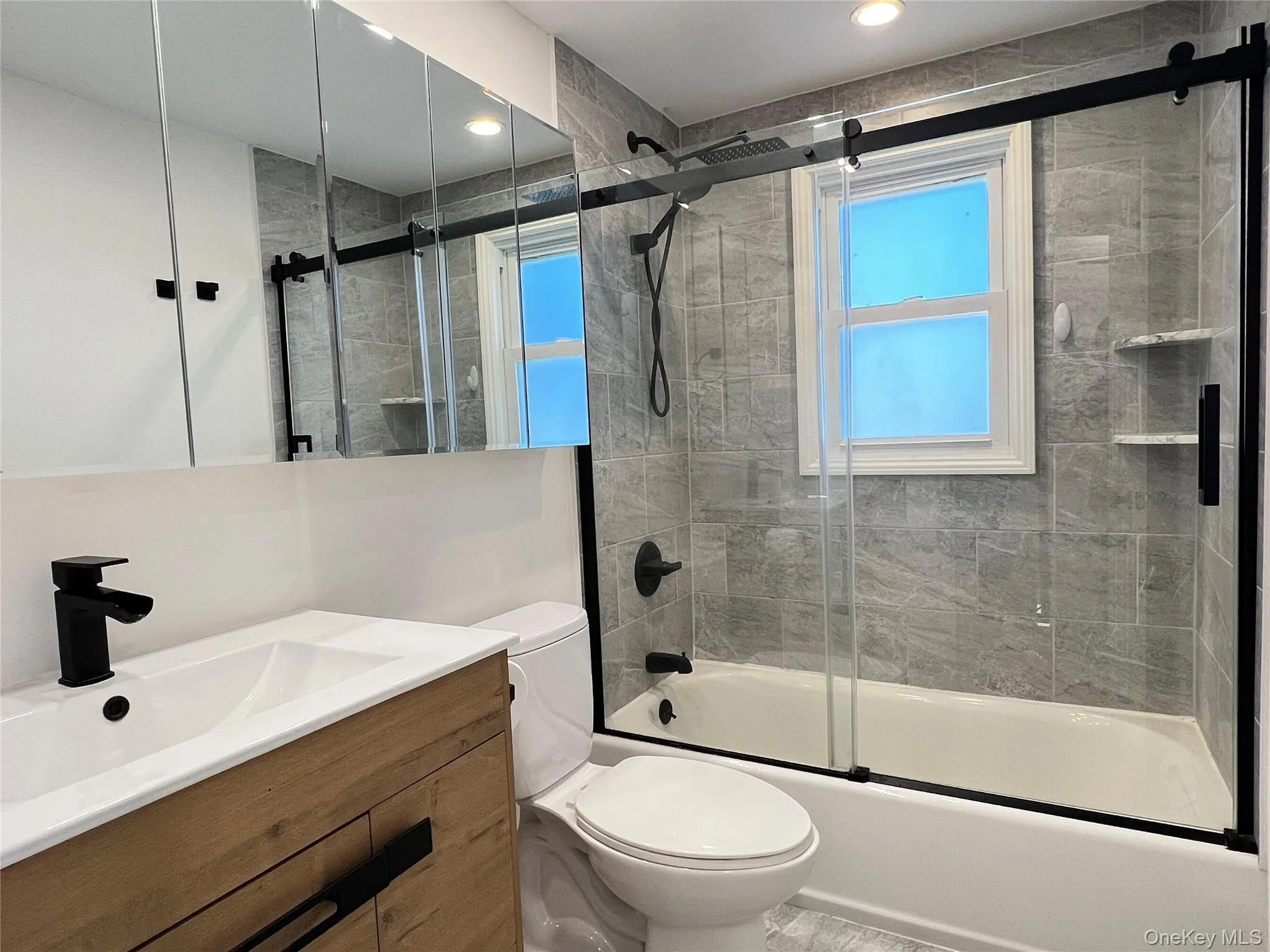 Bathroom with shower / bath combination with glass door and vanity Bathroom with shower / bath combination with glass door and vanity