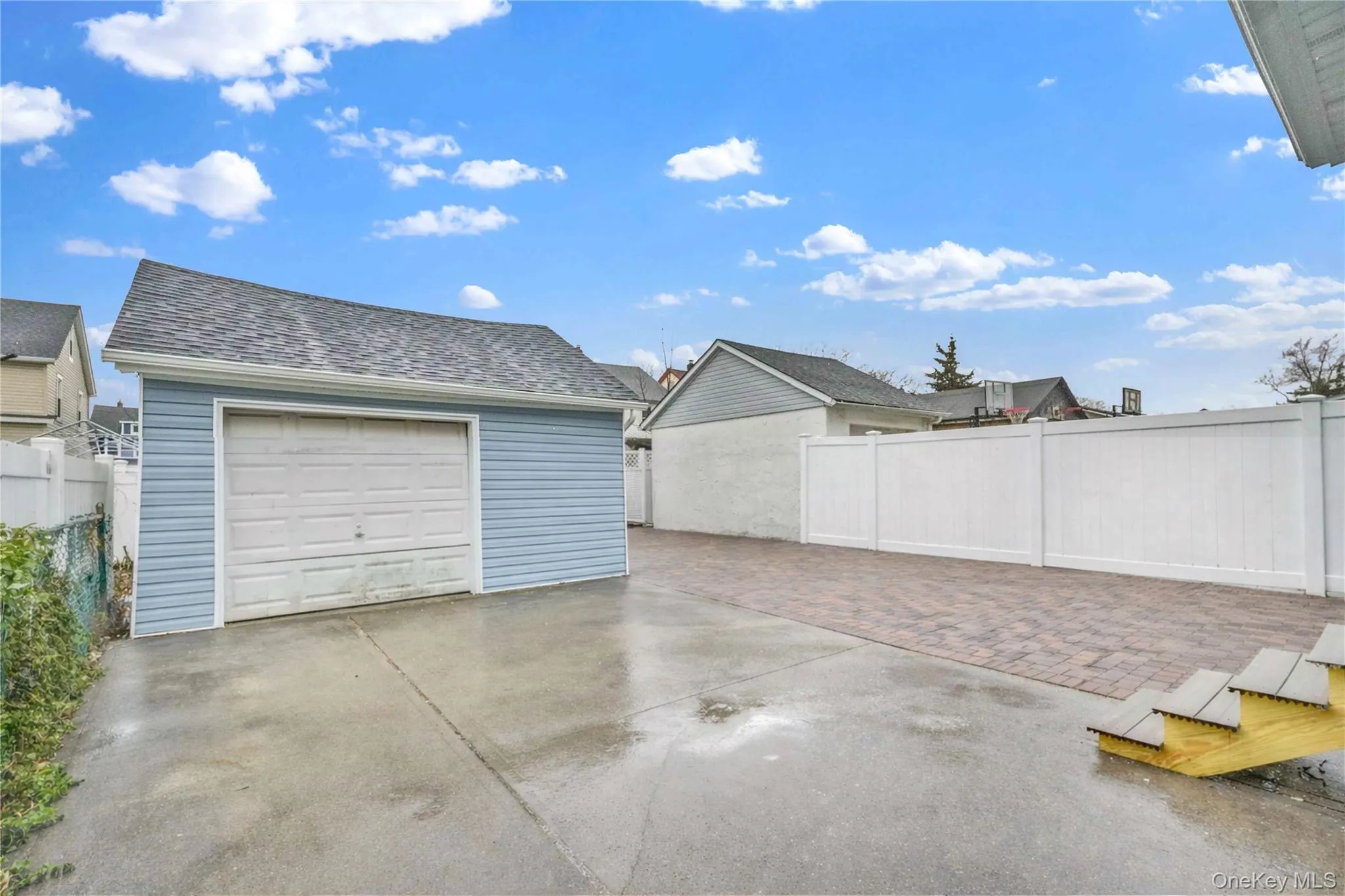 Detached garage featuring concrete driveway Detached garage featuring concrete driveway