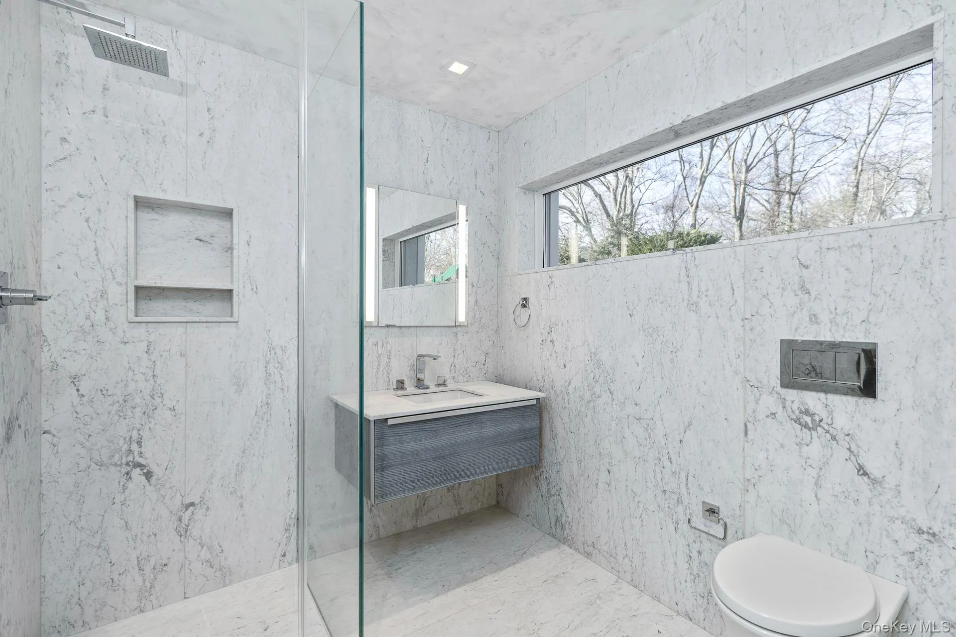 Bathroom with vanity and a marble finish shower Bathroom with vanity and a marble finish shower