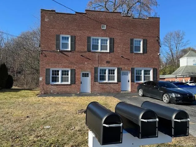 View of front of property with brick siding and a front lawn View of front of property with brick siding and a front lawn