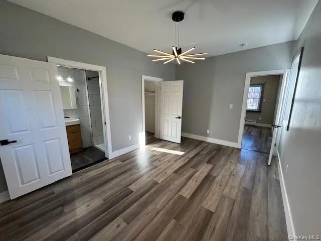 Spacious bedroom featuring a walk in closet, nice flooring, ceiling lights. Spacious bedroom featuring a walk in closet, nice flooring, ceiling lights.