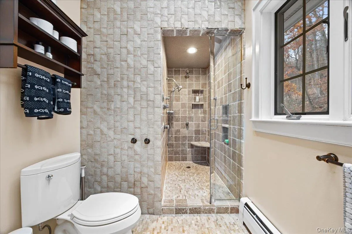 Full bath featuring a tiled shower Full bath featuring a tiled shower