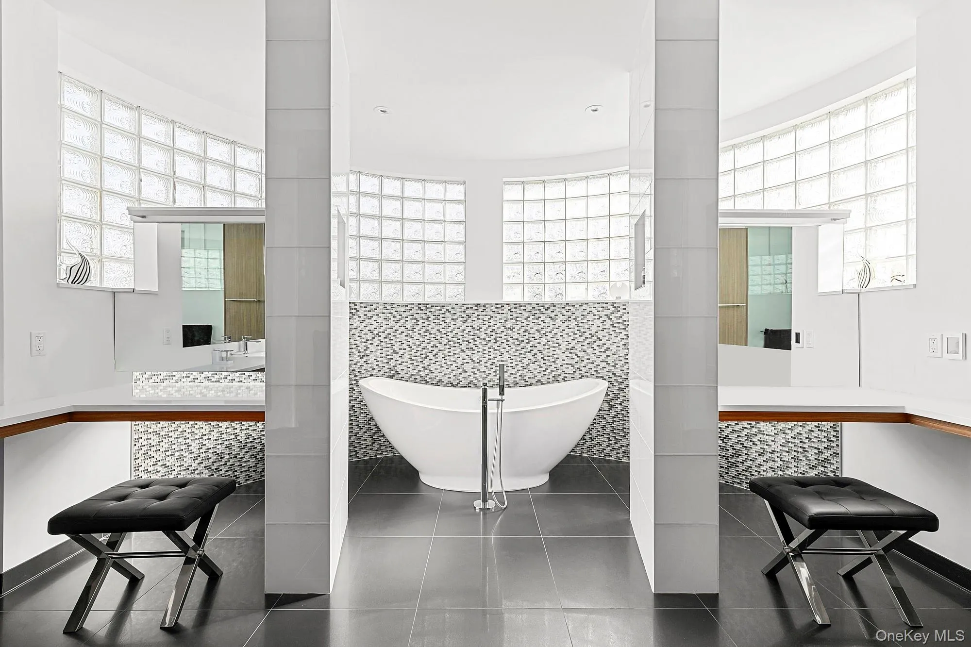 Bathroom featuring a soaking tub and vanity Bathroom featuring a soaking tub and vanity