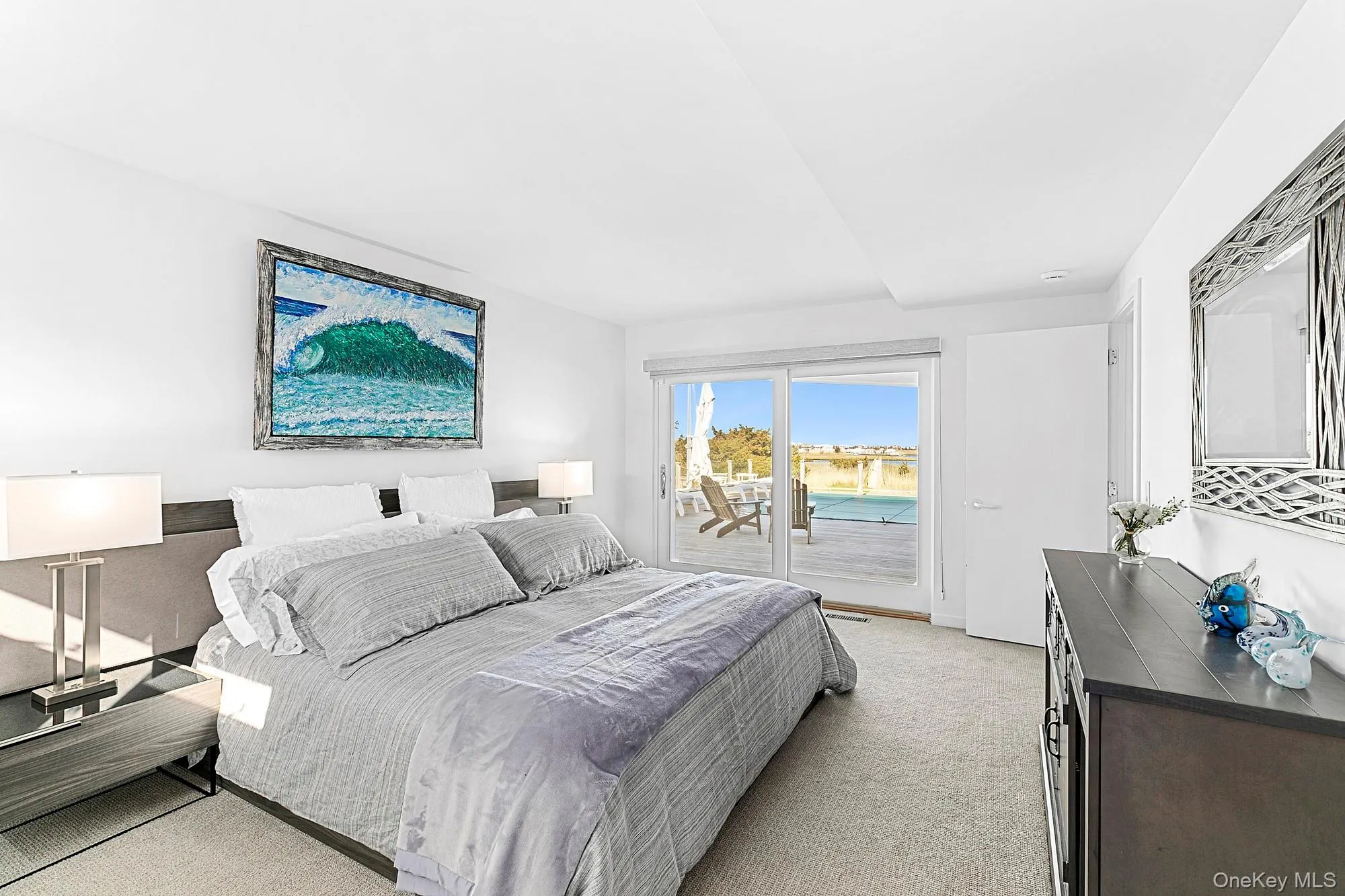 Bedroom featuring access to exterior and light carpet Bedroom featuring access to exterior and light carpet