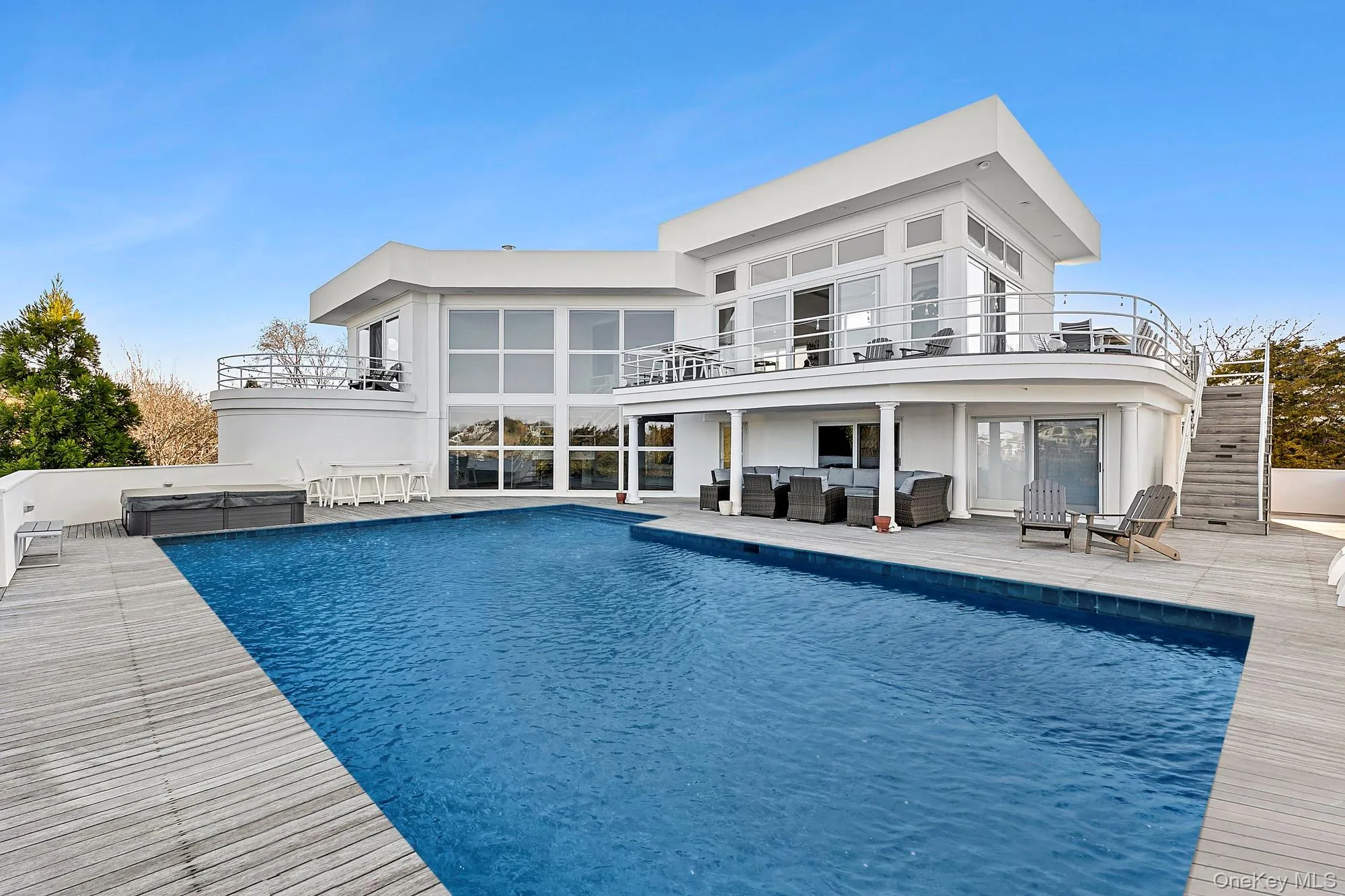 Back of property with stairs, outdoor lounge area, a patio area, and a balcony Back of property with stairs, outdoor lounge area, a patio area, and a balcony