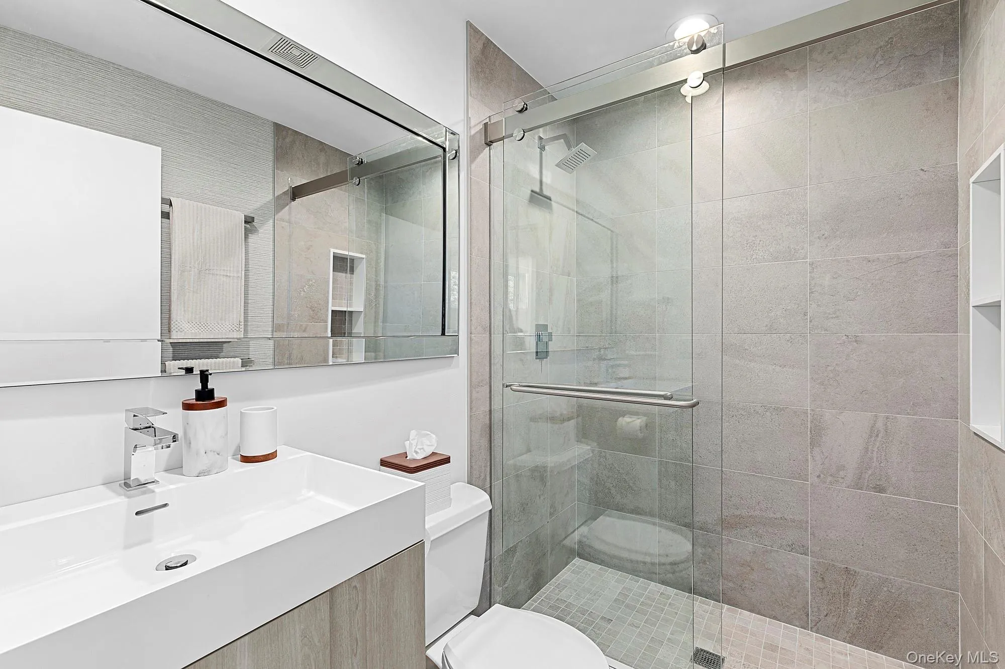 Bathroom with vanity and a shower stall Bathroom with vanity and a shower stall