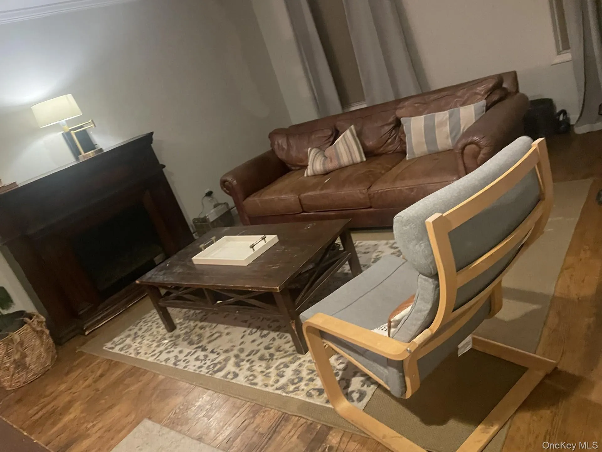 Living area with light wood-style flooring and a fireplace Living area with light wood-style flooring and a fireplace