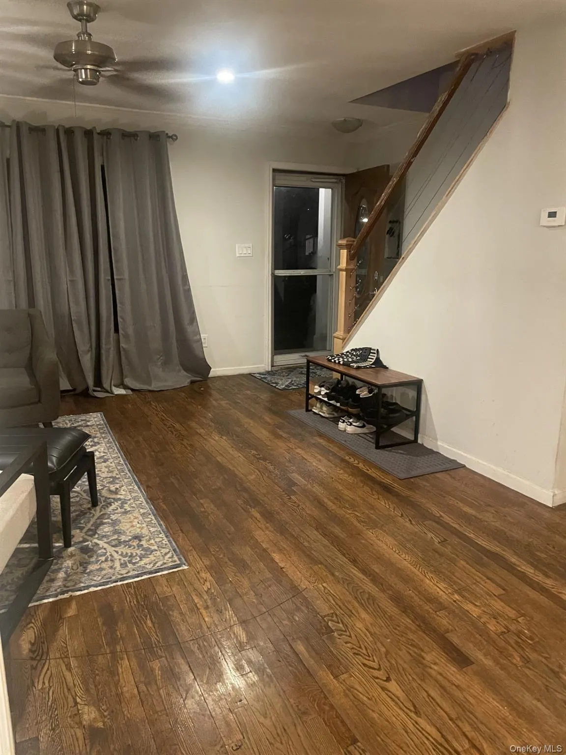Living room with dark wood finished floors and stairs Living room with dark wood finished floors and stairs