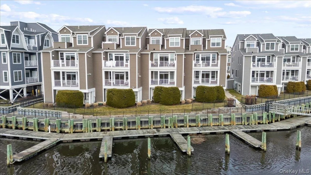 Back of house featuring a water view and a residential view Back of house featuring a water view and a residential view