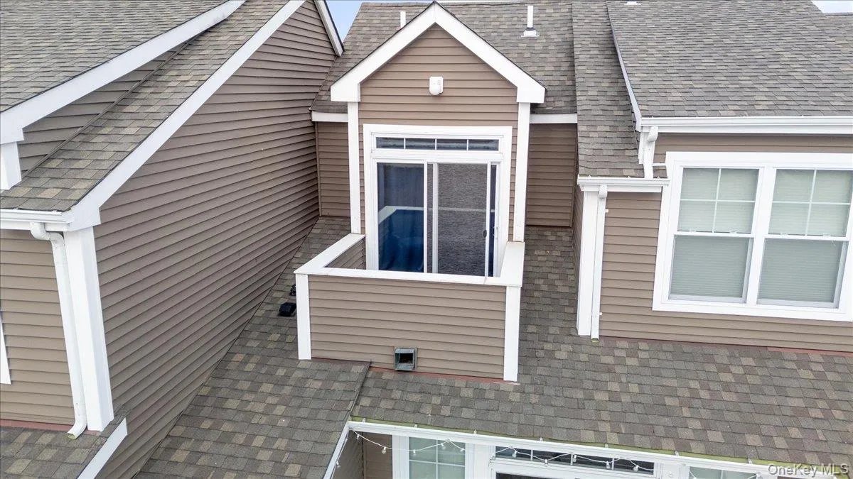 View of side of home with roof with shingles View of side of home with roof with shingles