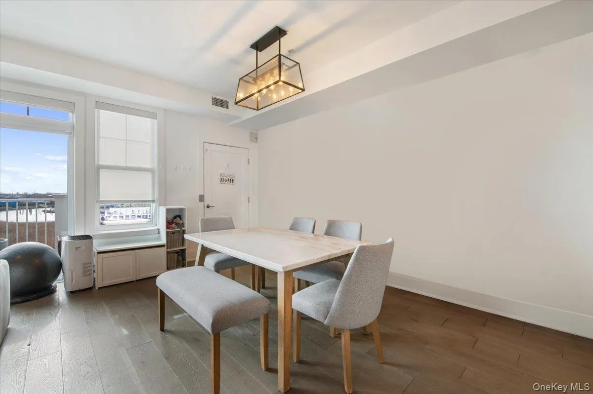 Dining room with wood-type flooring and baseboards Dining room with wood-type flooring and baseboards