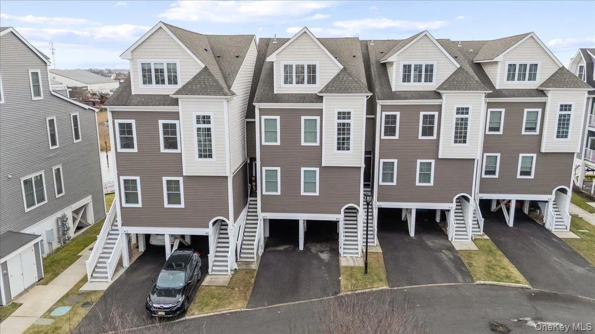 View of property featuring a residential view, a carport, and stairway View of property featuring a residential view, a carport, and stairway